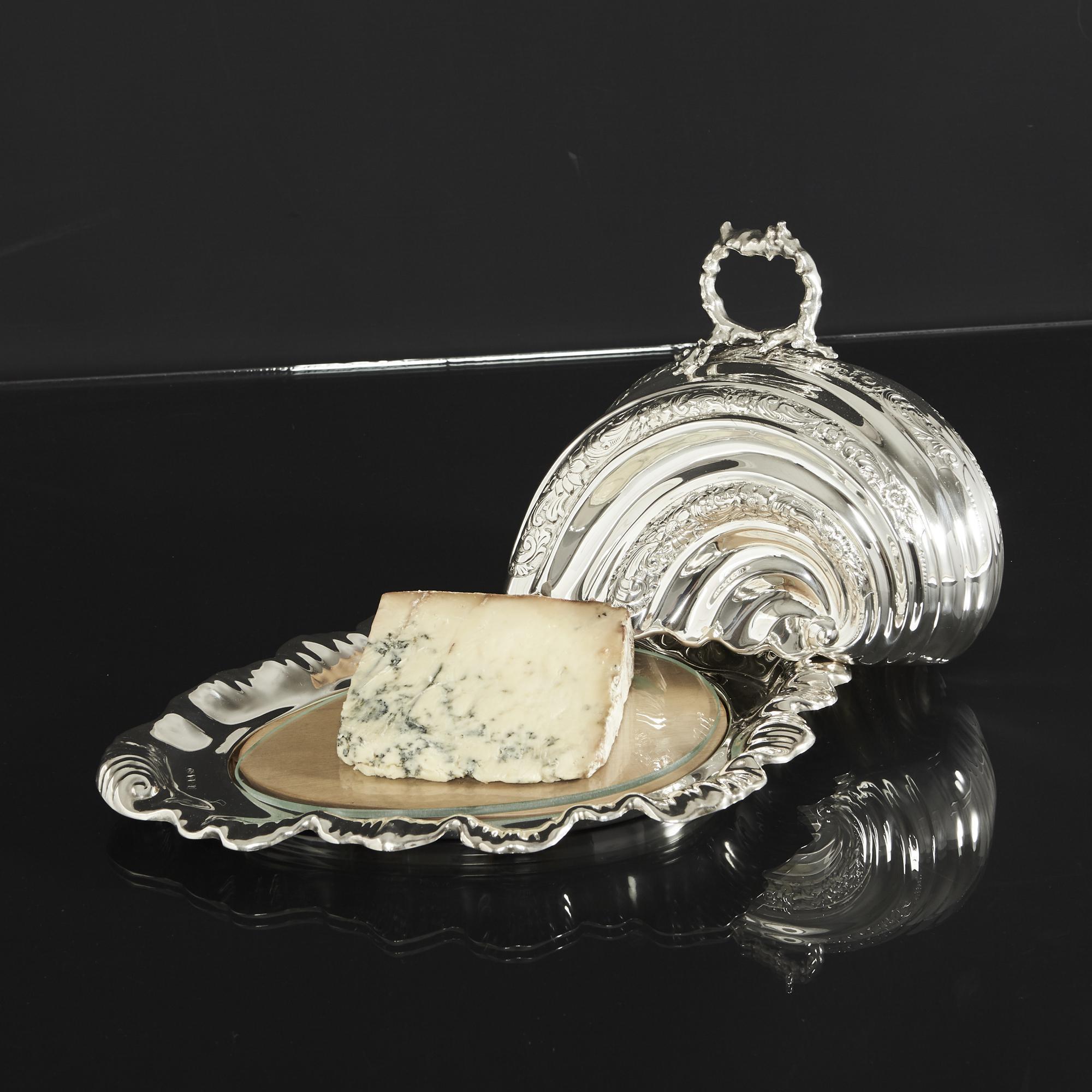 A rare and interesting serving dish and lid with marine themes. The base has a wave effect border with stylised shell ending and has been fitted with a wooden serving board. The lid is formed as a seashell with bands of hand-chased floral decoration