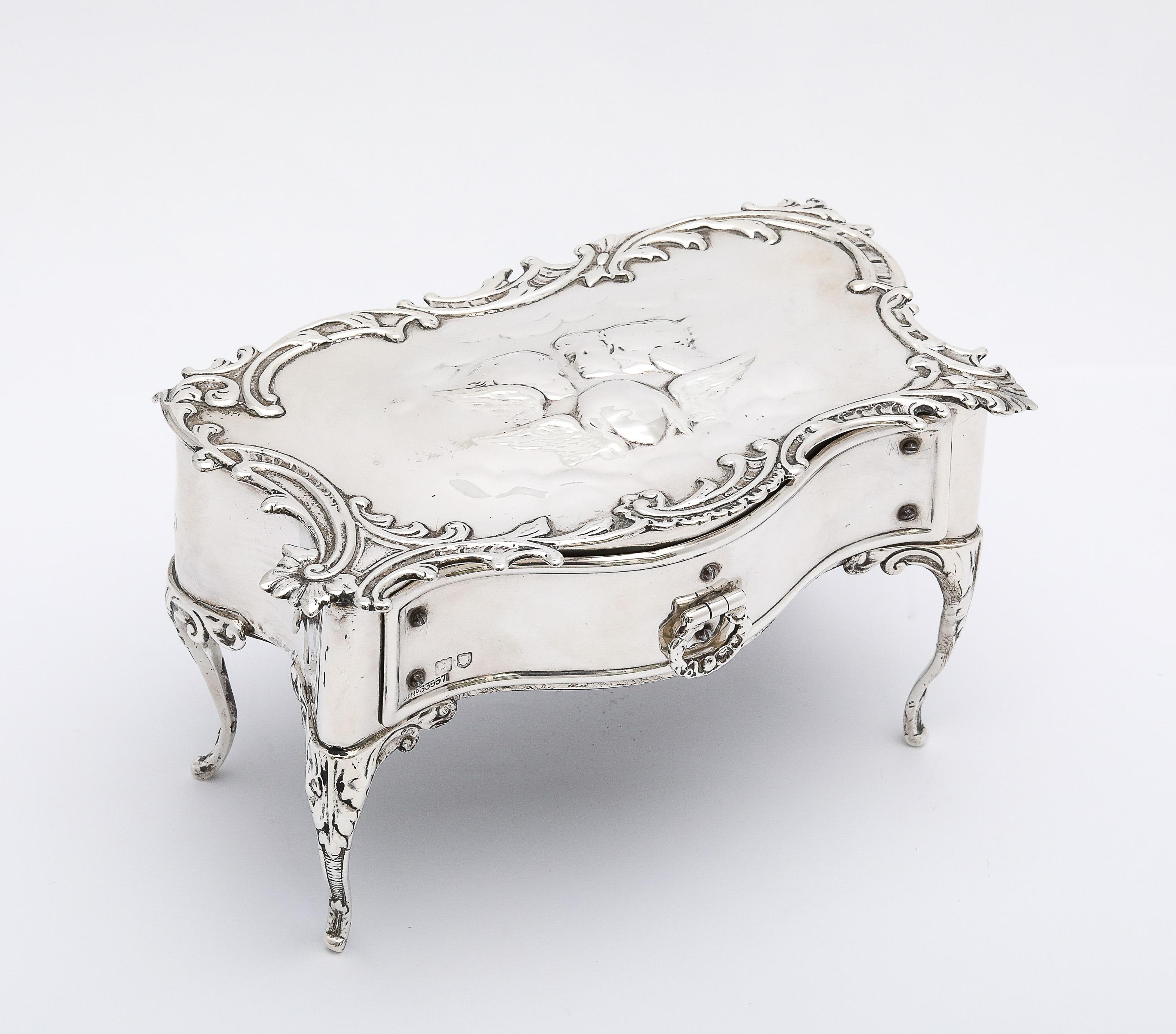 Rare boîte à bijoux à pied en argent sterling de la période édouardienne, de style victorien, Londres, Angleterre, poinçonnée pour 1902, William Comyns - fabricant. Le dessus de la boîte est orné du motif des Chérubins dans les nuages de Joshua