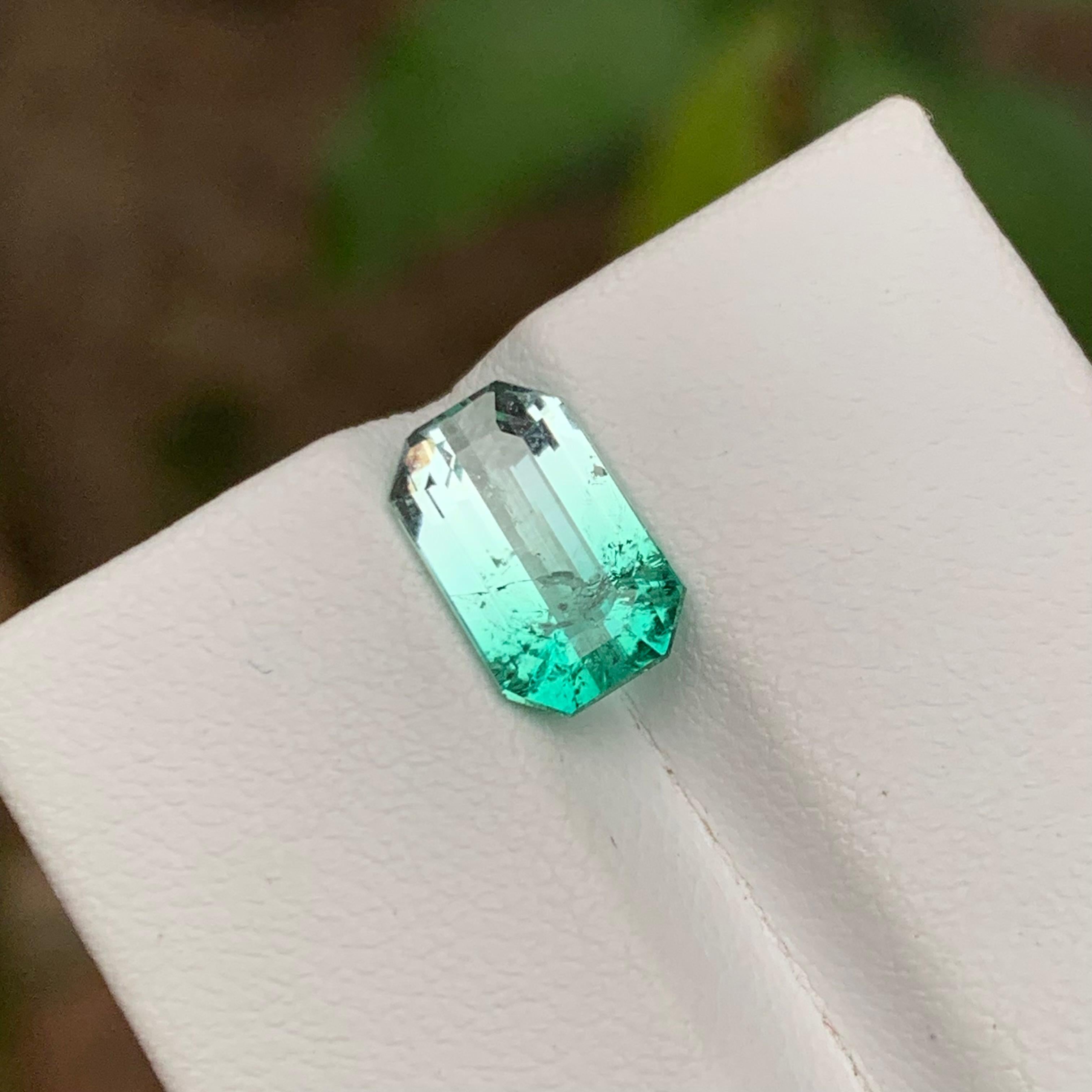 GEMSTONE TYPE: Tourmaline
PIECE(S): 1
WEIGHT: 2.65 Carats
SHAPE: Emerald
SIZE (MM): 10.36 x 6.52 x 4.64
COLOR: Electric Bluish Green & White Bicolor
CLARITY: Slightly Included 
TREATMENT: None
ORIGIN: Afghanistan
CERTIFICATE: On demand

here’s an