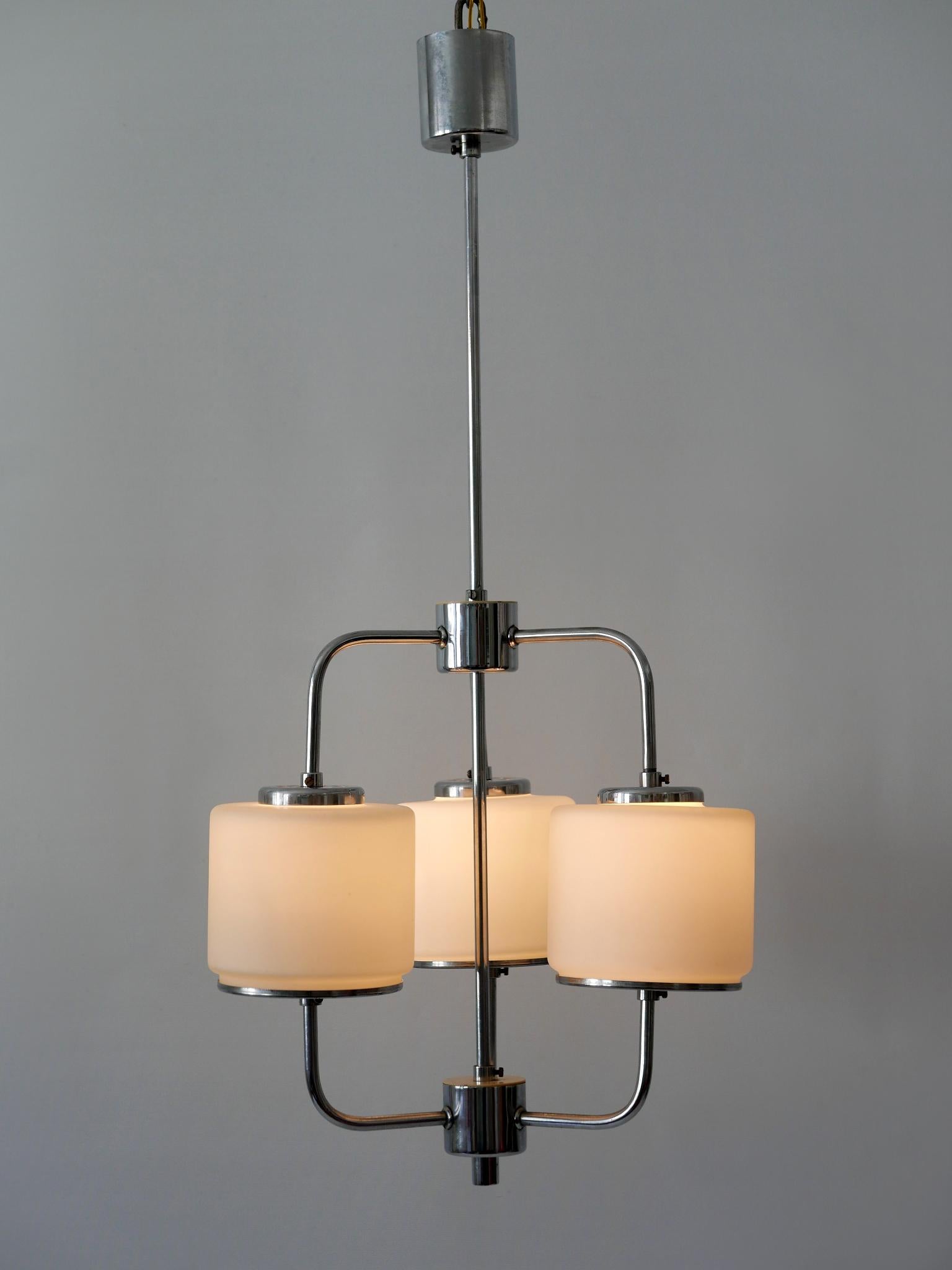 Rare and beautiful Bauhaus or Art Deco pendant lamp or chandelier. Designed & manufactured in Germany, 1930s.

Executed in opaline glass and chrome-plated brass, the pendant lamp/chandelier needs 3 x E27 / E26 Edison screw fit bulbs. It is wired,