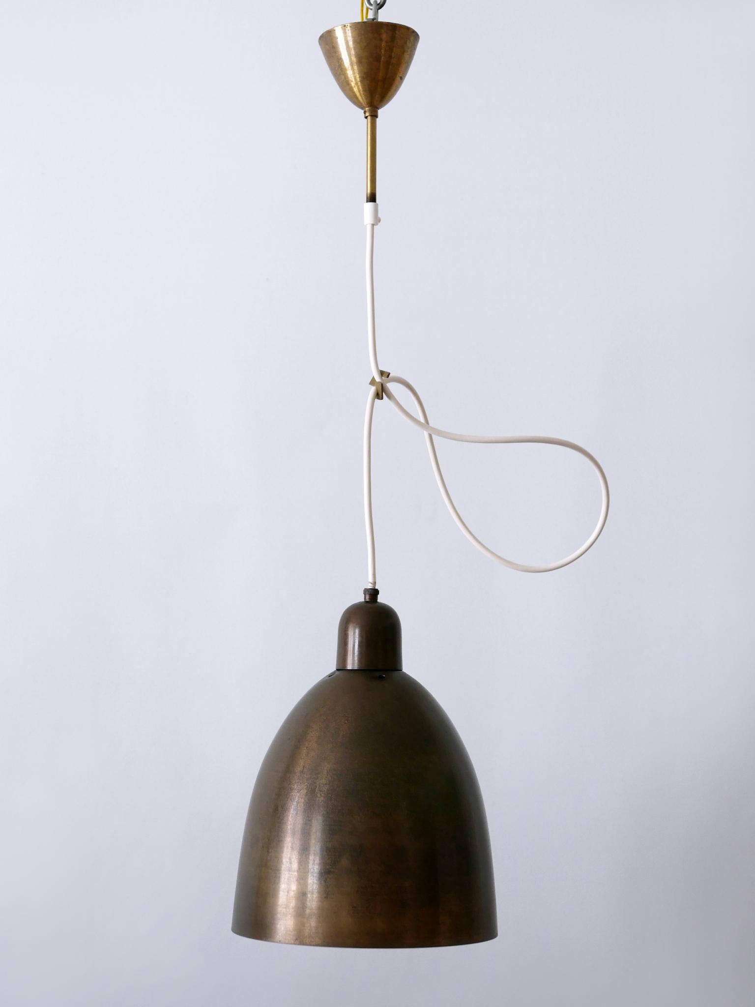 Rare, elegant and highly decorative Mid-Century Modern solid brass pendants lamp or hanging lights. They had been in use in a German church. Designed & manufactured in Germany, 1950s.

A total of seven identical lamps are available. Price per