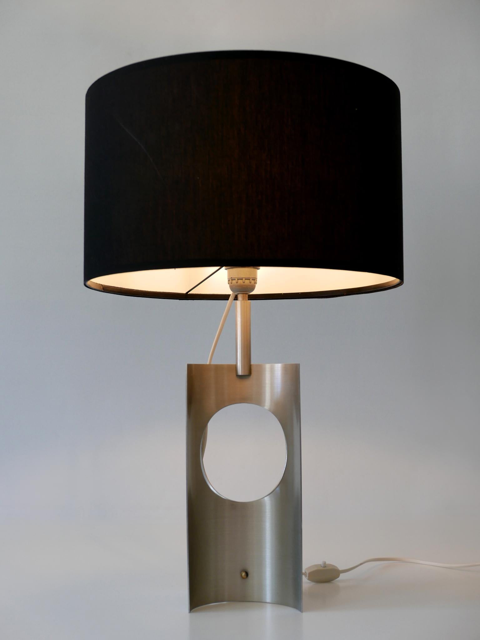 Extremely rare and elegant Mid-Century Modern side table lamp. Designed & manufactured probably in France, 1970s.

Attention please: The table lamp will be sold without lamp shade!

Executed in brushed aluminum, the table lamp comes with 1 x E27 /