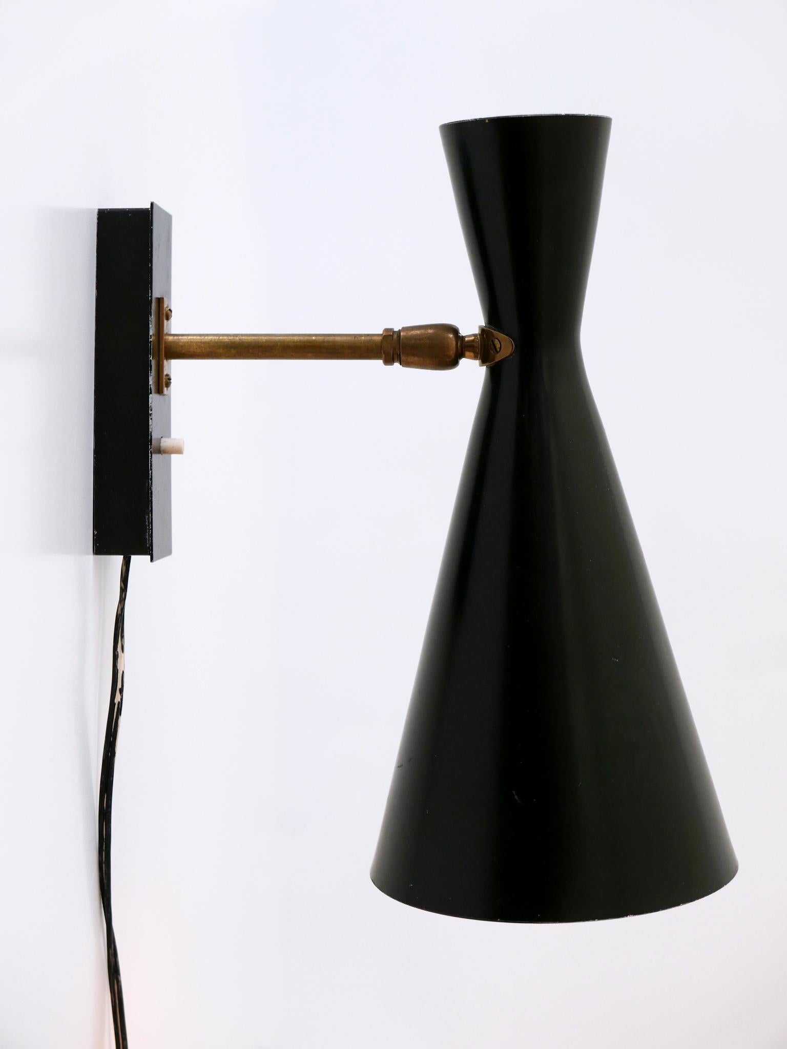 Rare, elegant and highly decorative Mid-Century Modern sconce or wall lamp. Shade adjustable in various position due to the joint ball. Manufactured by BAG Turgi, Switzerland, 1950s.

Executed in brass, aluminium and metal, the sconce comes with 1