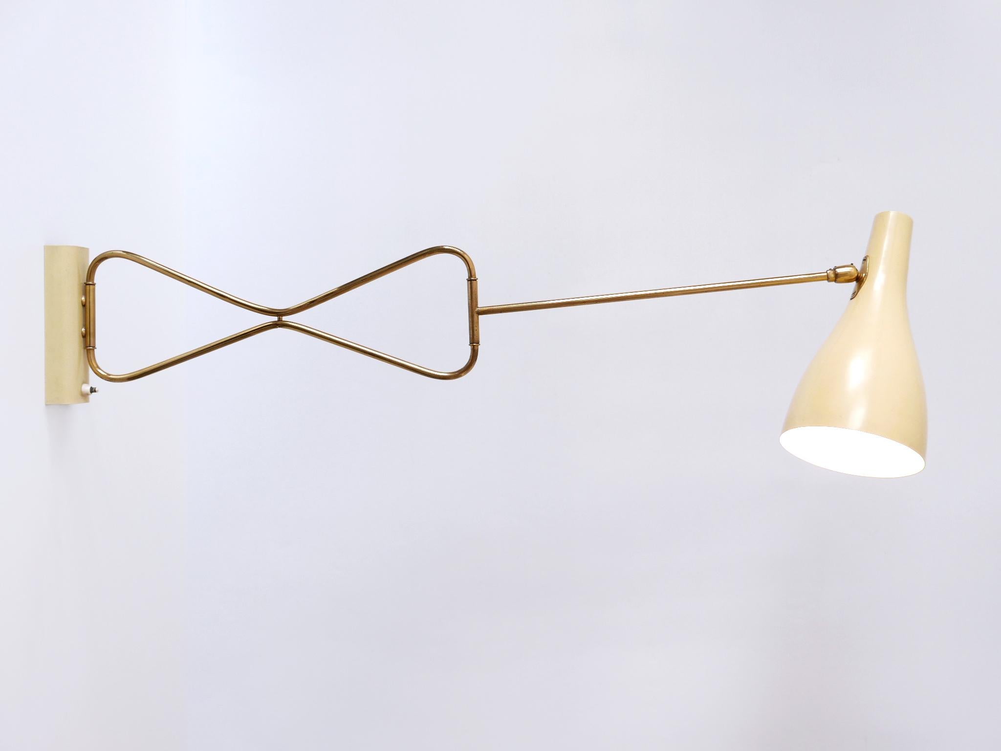 Extremely rare and elegant Mid-Century Modern articulated wall lamp. Model No:  '9590/28'. Designed & manufactured by Gebrüder Cosack, Germany, 1950s. 

Executed in brass and aluminium, the wall lamp is executed with  1 x E27 / E27 Edison screw fit