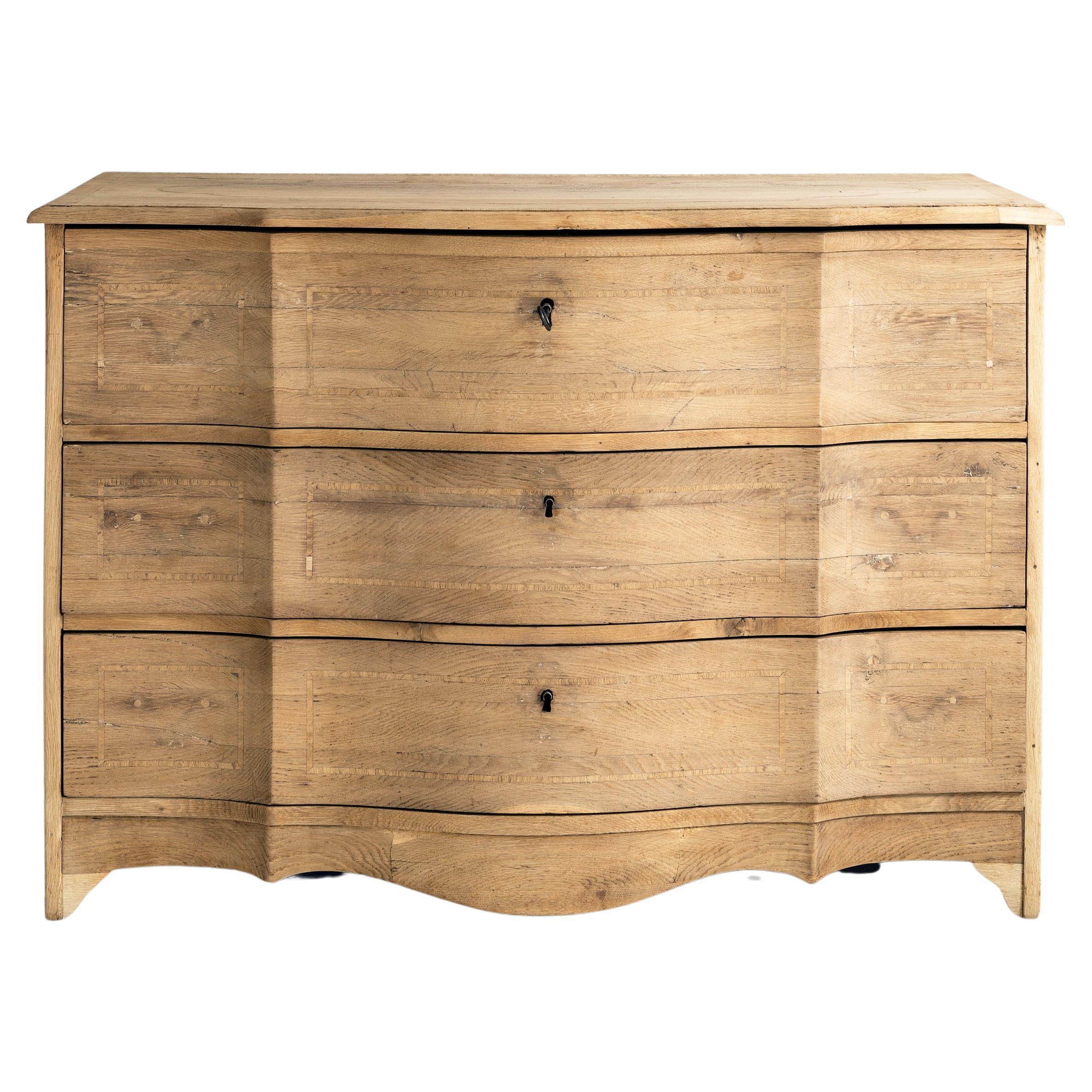 Beautiful simple Swedish, Danish, or Schleswig- Holstein 18th century Baroque commode Galbée in oak. Soft, undulating lines to the front, punctuated by a two sharp folds. Beautyful pale oatmeal color and silky smooth finish. 
What makes this piece