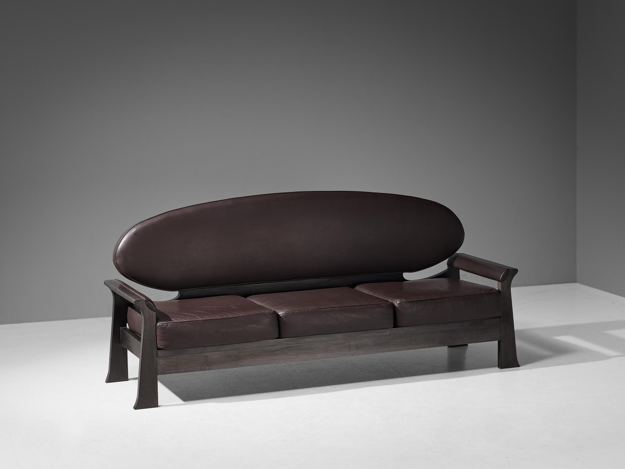 Emiel Veranneman for De Coene, 'Osaka' sofa, stained oak, leather, Belgium 1968.

The Belgian designer Emiel Veranneman is a specialist in balancing decorative and structural components in furniture, and this sofa is a prime example of that. In