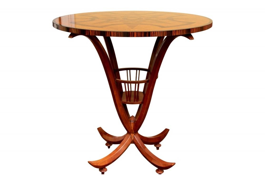 Extraordinary John Widdicomb sculptural table designed by Emilio Terry with an elaborate geometric inlay of walnut burl, rosewood and walnut set in a field of maple burl and ebony banding. The four sculptural legs conjoined with a basket and the