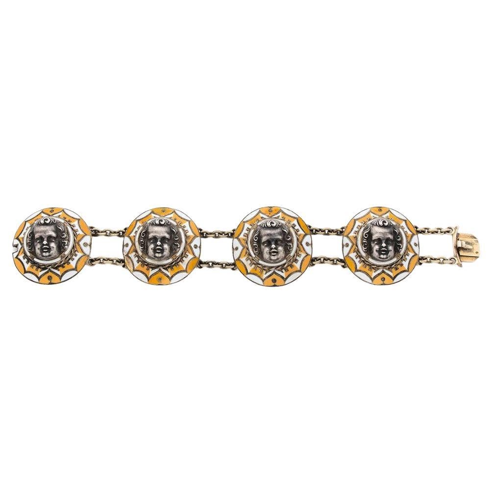 Il est composé de quatre maillons ronds décorés au centre d'un angelot dans un entourage d'émail jaune vif et blanc dans des réserves de fils d'or. Marque de fabrique de F-J. RUDOLPHI.
Poids : 54,16 gr.
Dimensions : 20 x 3,8 cm : 20 x 3,8