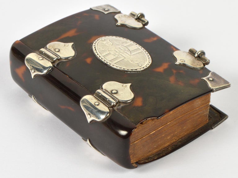 This pocket size prayer book dates to 1774 where it was published by C. Eyre and W. Strahan. At a certain time, likely in the mid-19th century, it has been mounted in a tortoise shell cover with silver (unmarked) closure, hinges and corners and the