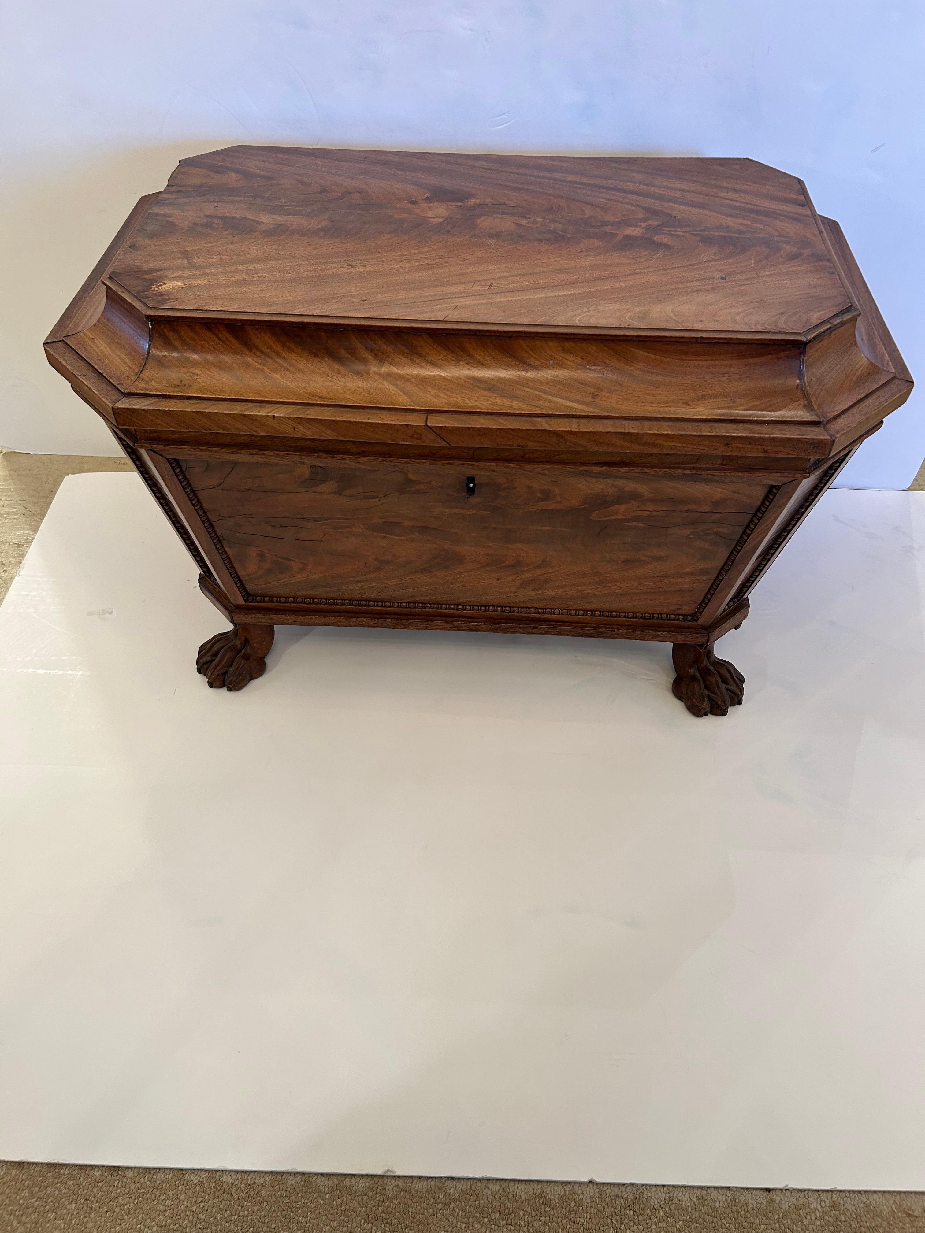 Incredible large English Regency antique cellarette wine cooler in a blonde light color wood, beautifully grained, having carved paw feet and original lead liner.  A rare find with marvelous age and patina.