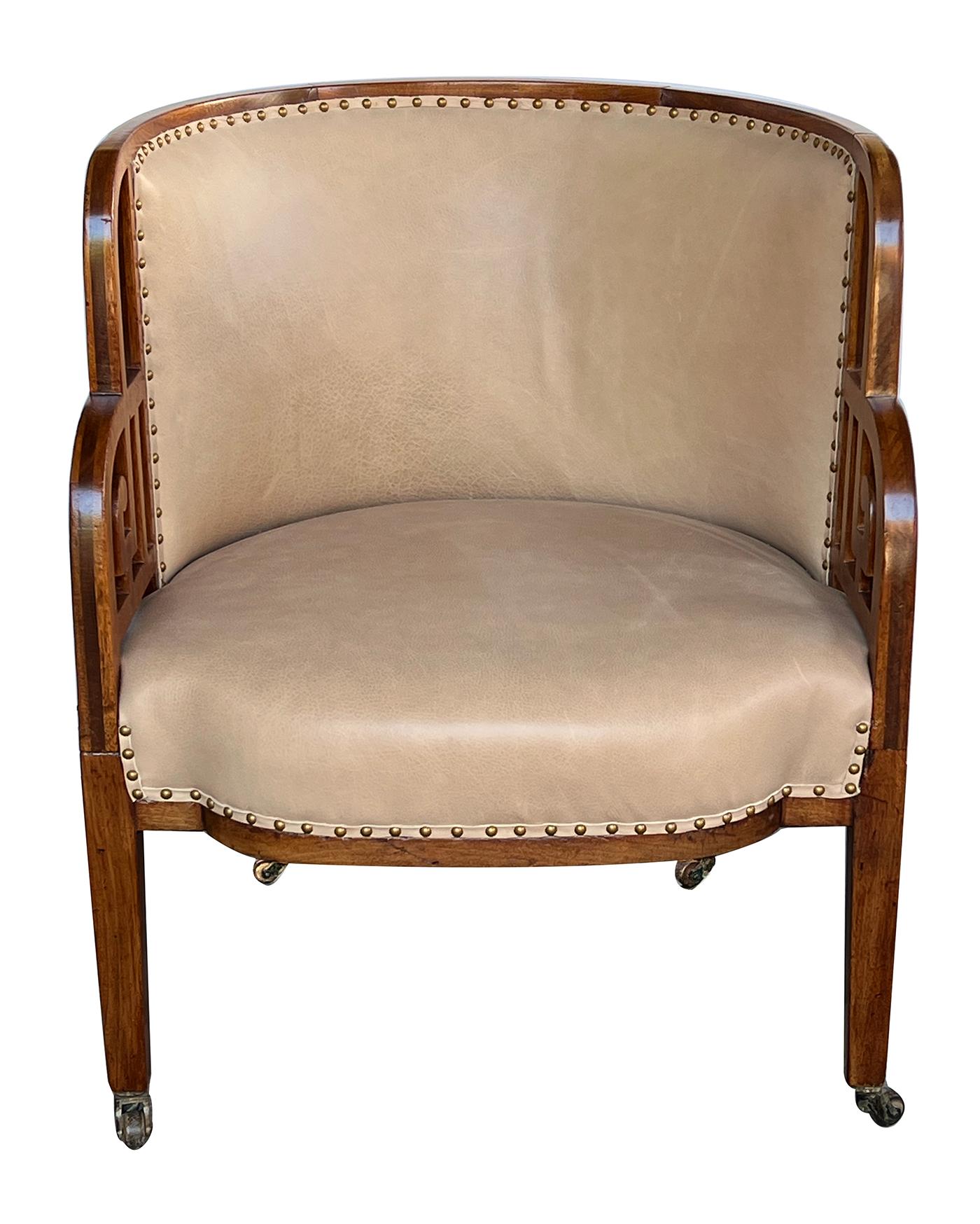 the framed in-curved back above a bowed upholstered seat flanked by openwork sides; all raised on tapering legs ending in casters.