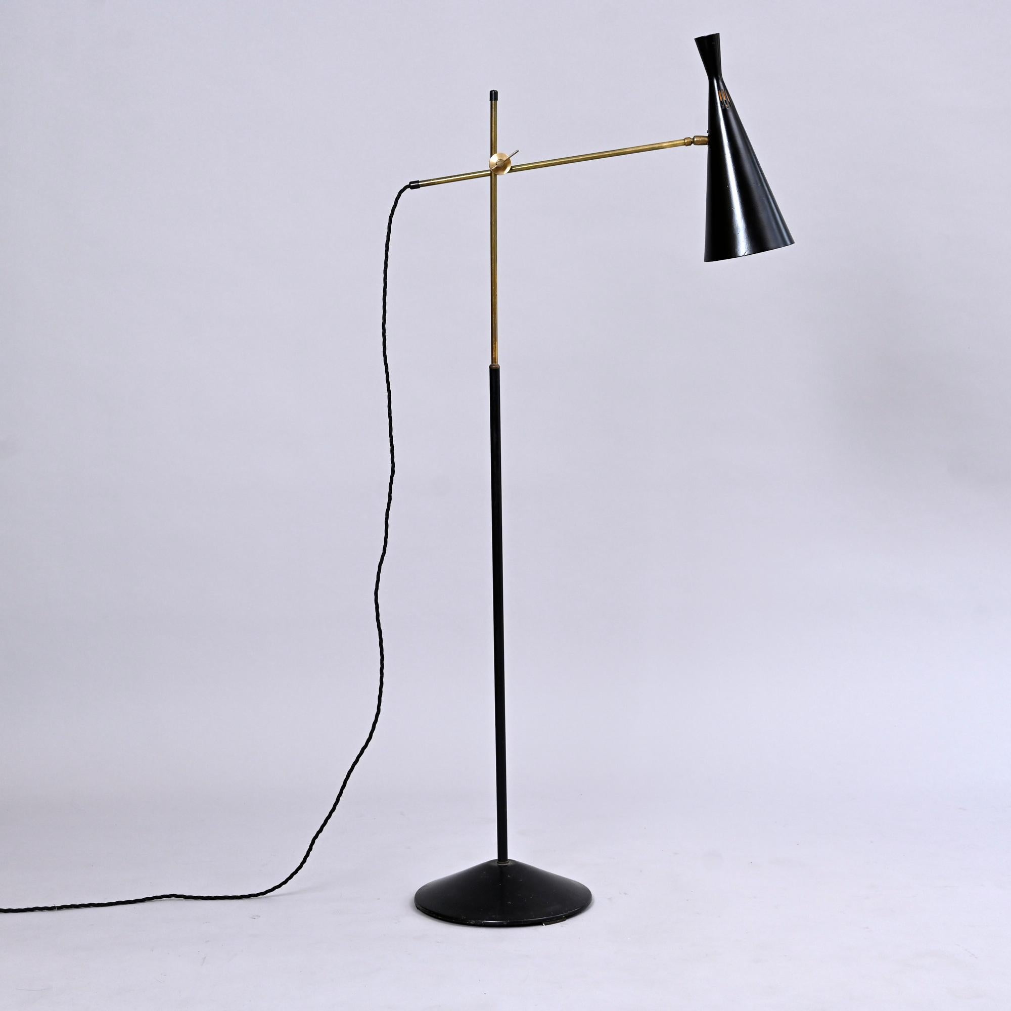 A beautiful 1950s floor lamp. 

Designed by GA Scott for Maclamp, UK, England. 

With black metal shade and base, and brass fittings. 

Fully functional and re wired.