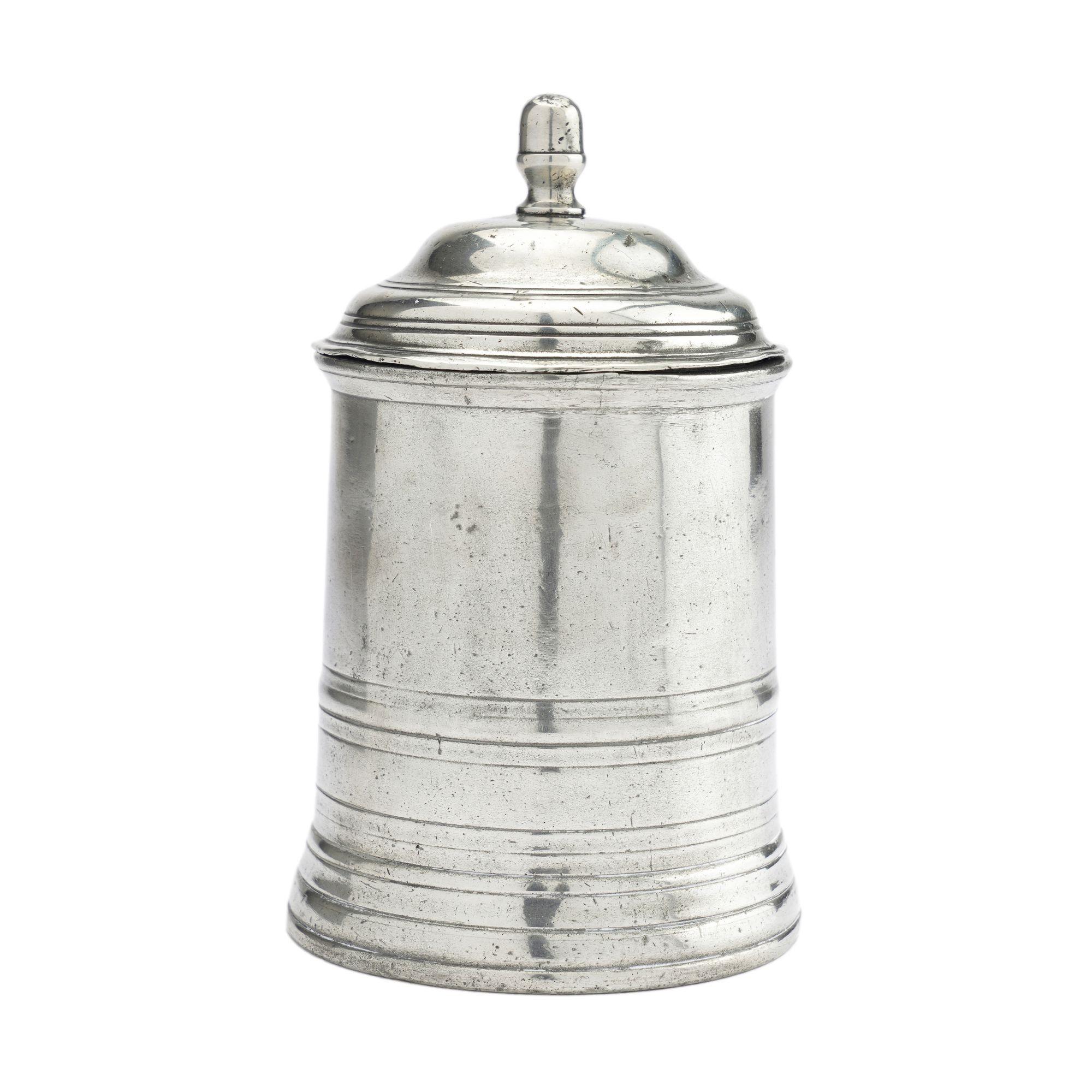A rare George III pewter tea/tobacco canister. The beaded lip is repeated in ring moldings on the domed lid which terminates in an acorn finial. The canted base of the canister repeats the series of ring turned moldings. Engraved Palmer script