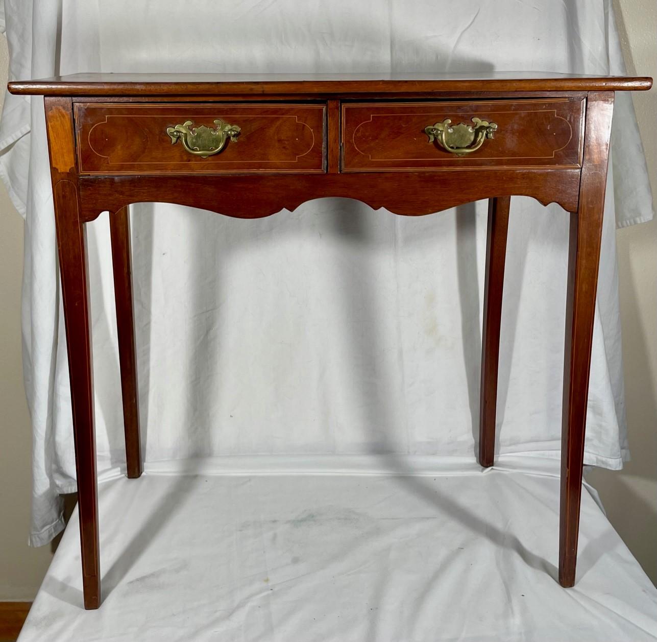 Rare English Georgian side table, circa 1760.

Fabulous 18th century side table, an example of Hepplewhite period elegance. This rare side table is crafted in superb quality with crossbanding and stringing around the edge of the top and down the