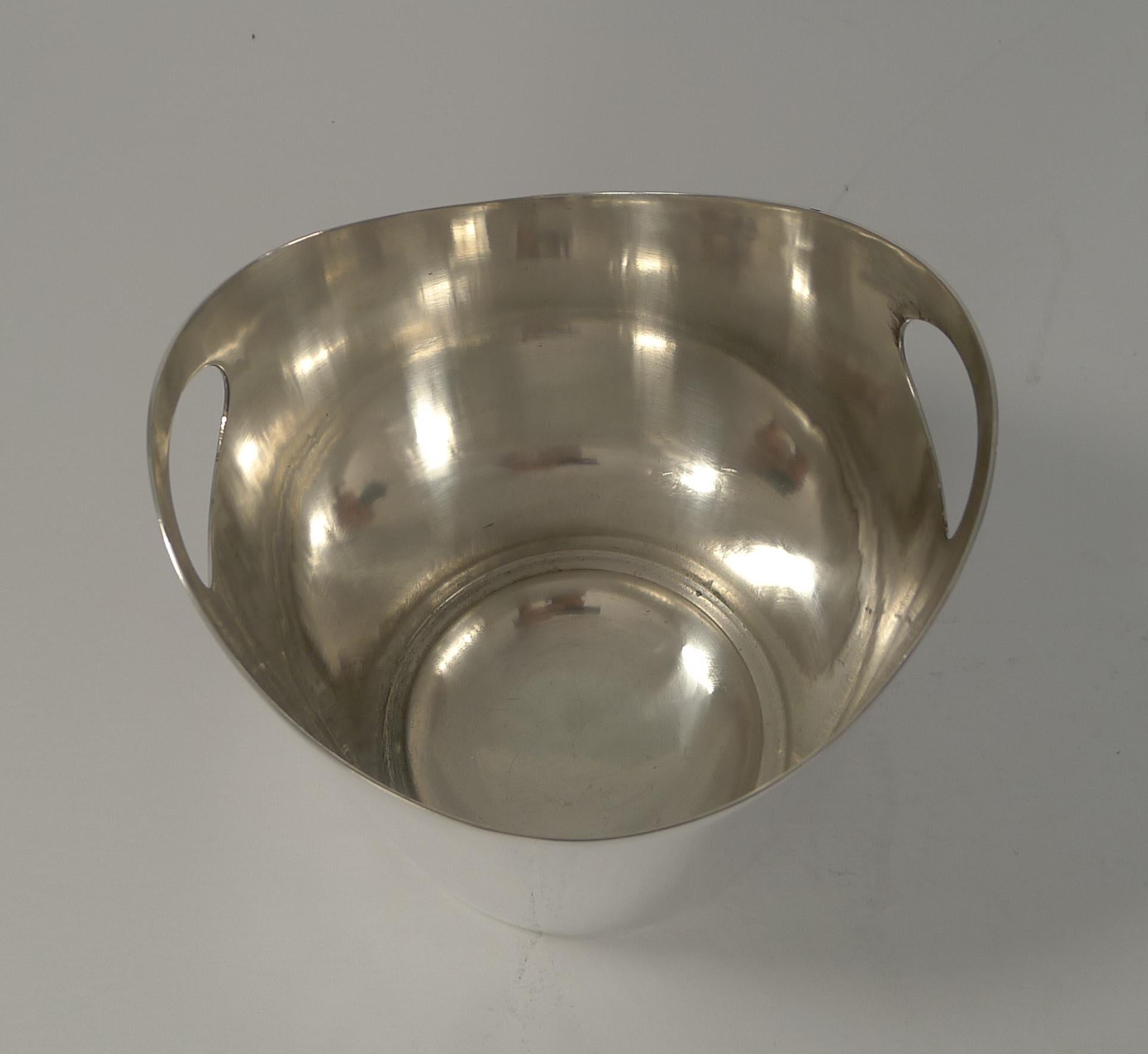 A fabulous and most unusual ice bucket in a clean modern midcentury design by the top notch Sheffield silversmith, Walker and Hall.

Just back from our silversmith having been professionally cleaned and polished, the stylish shape has cut-out
