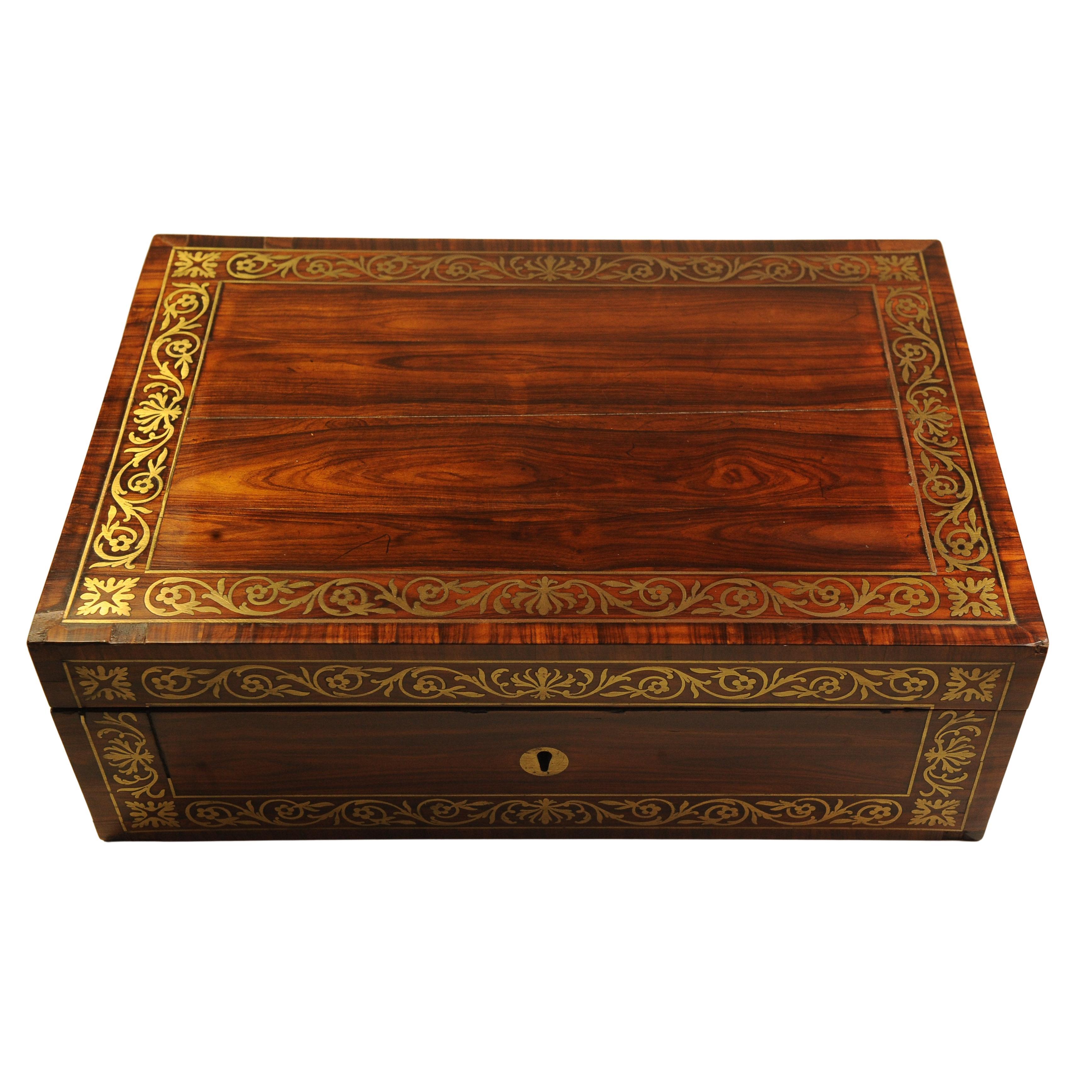 A Beautiful Handcrafted 19th Century Hardwood Veneer Writing Slope With A Tooled Purple Leather Writing Liner. Item Featured Brass Carry Handles & Is Finished With A Decorative Brass Inlay. Manufactured By Esteemed Maker Wells & Lambe.

Item will