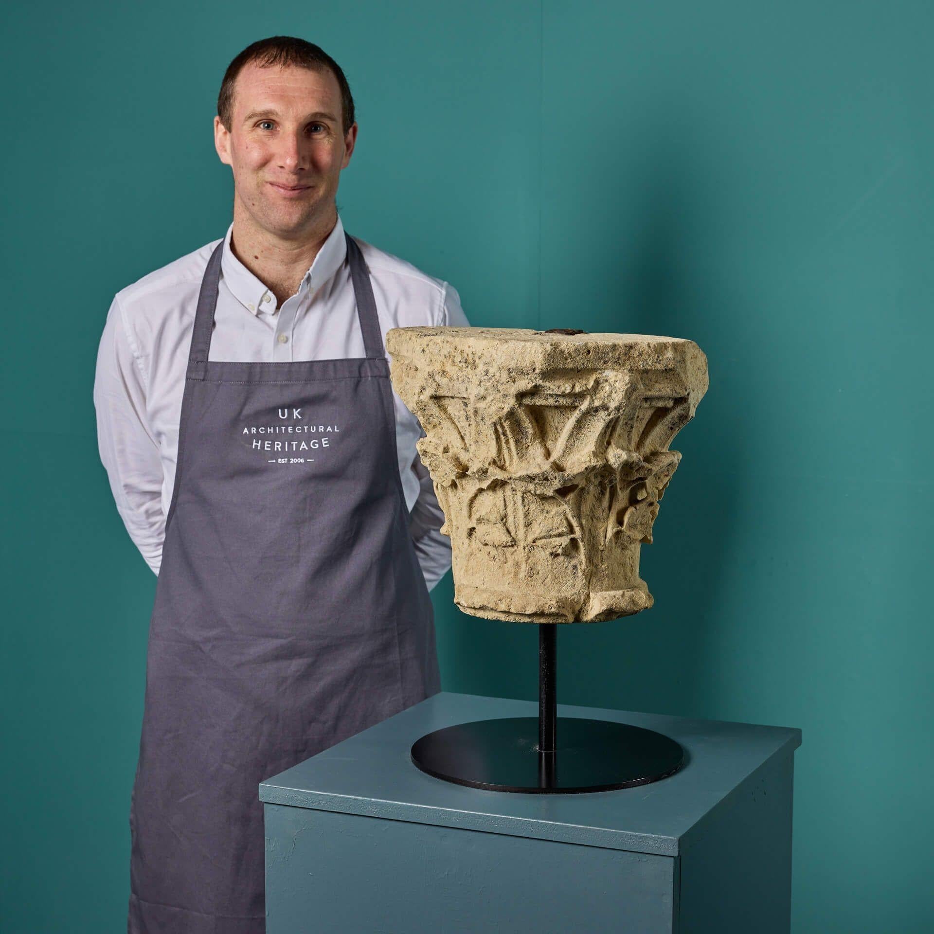 This weathered English Romanesque limestone capital is centuries old, dating from the Norman era of the 11th and 12th centuries. Originating from Oxfordshire, it is decoratively hand carved, perhaps once forming part of an interior or exterior of a