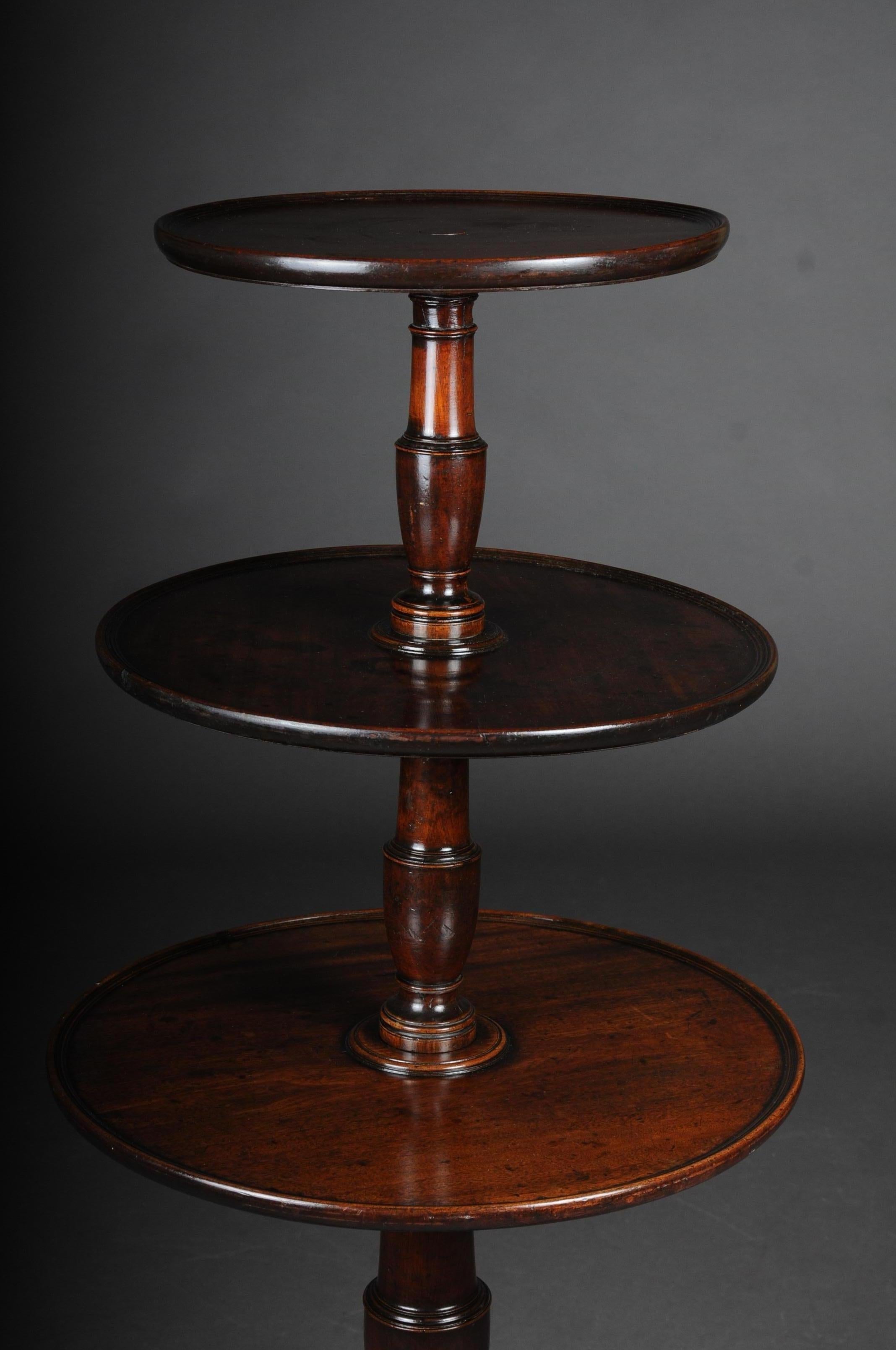 Rare English side table or étagère, Victorian 19th century mahogany

Solid mahogany wood with three-tier and round shelves. Pillar shaft, turned and also made of solid mahogany. Basalt table or étagère standing on 3 curved legs with caster feet