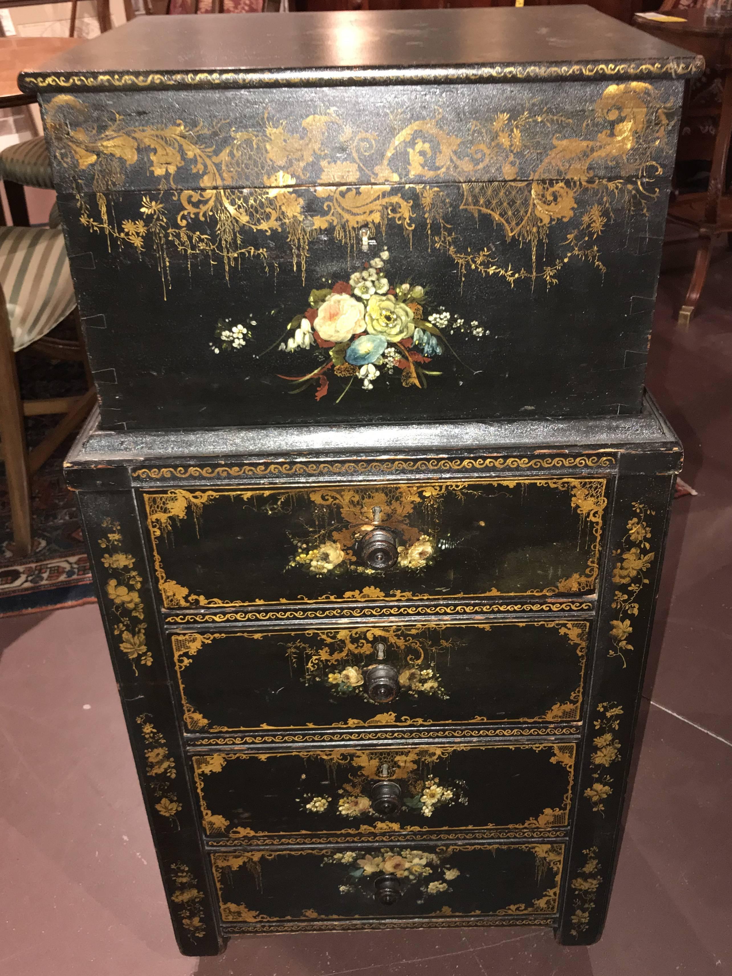 What a rare and unusual find! An English Victorian two part ladies ebonized Campaign chest or cabinet with brass side handles, its upper case with a hinged top for documents, and the lower case with delicate waist molding over three drawers, and a