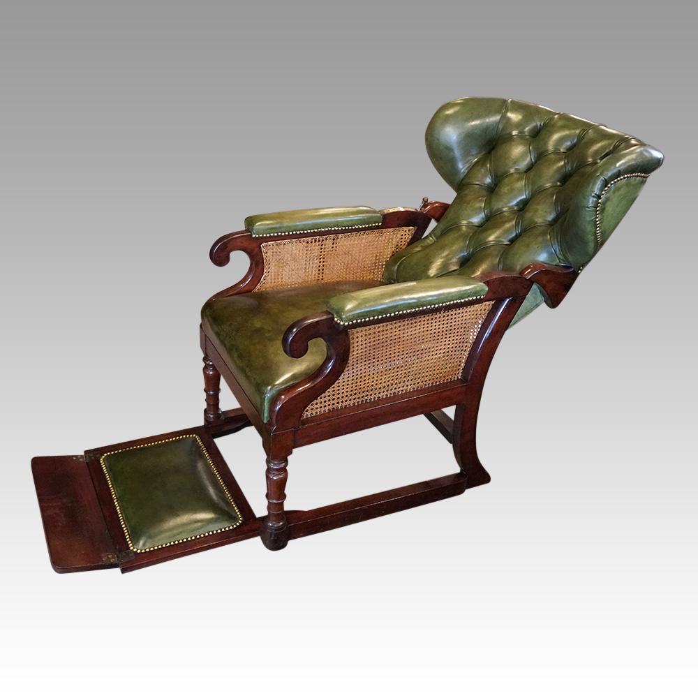This rare Victorian mahogany reclining library chair was made circa 1840.

The mahogany frame with the sliding footrest that is stored under the chair, then slides out on a runner for you to use if required.

The buttoned leather wing-back