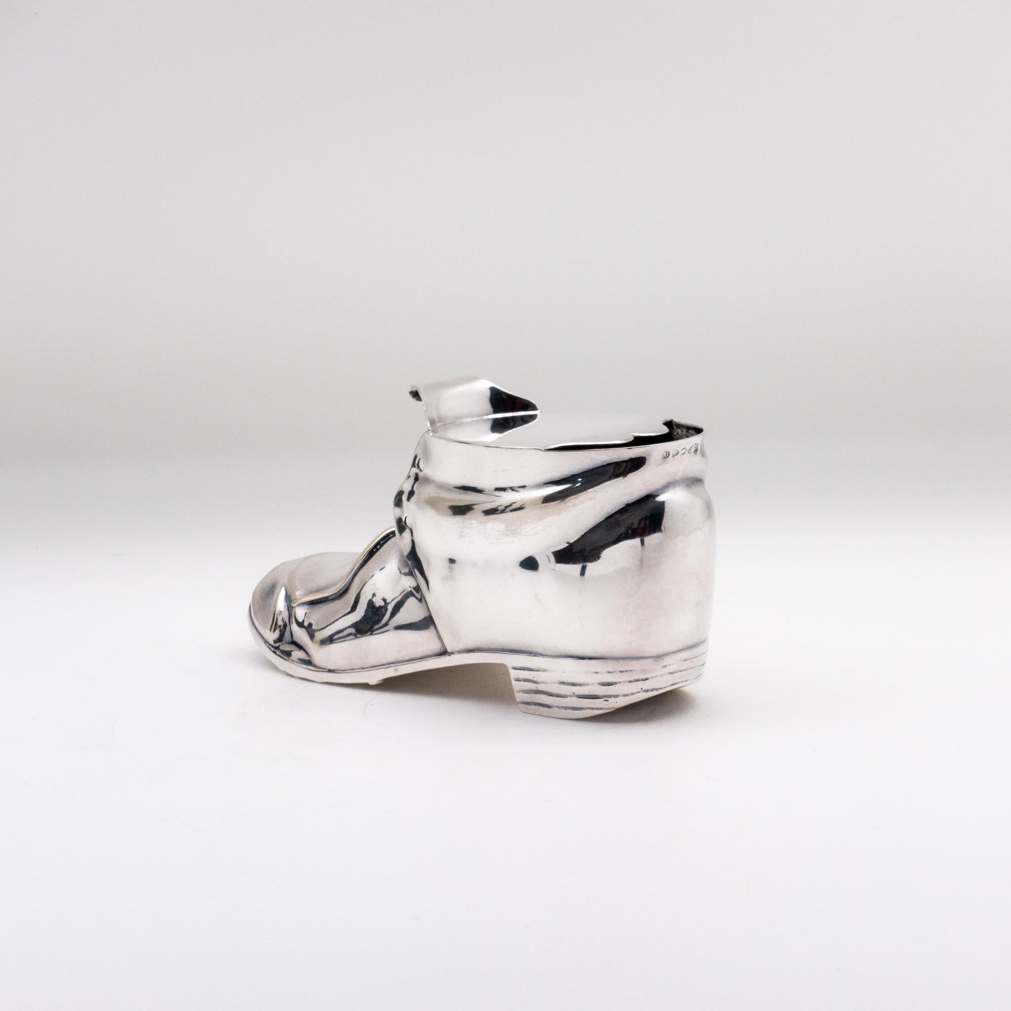 An antique Victorian silver plated spoon warmer, in the shape of a leather shoe. Made by Thomas Latham & Ernest Morton of Birmingham, England.
