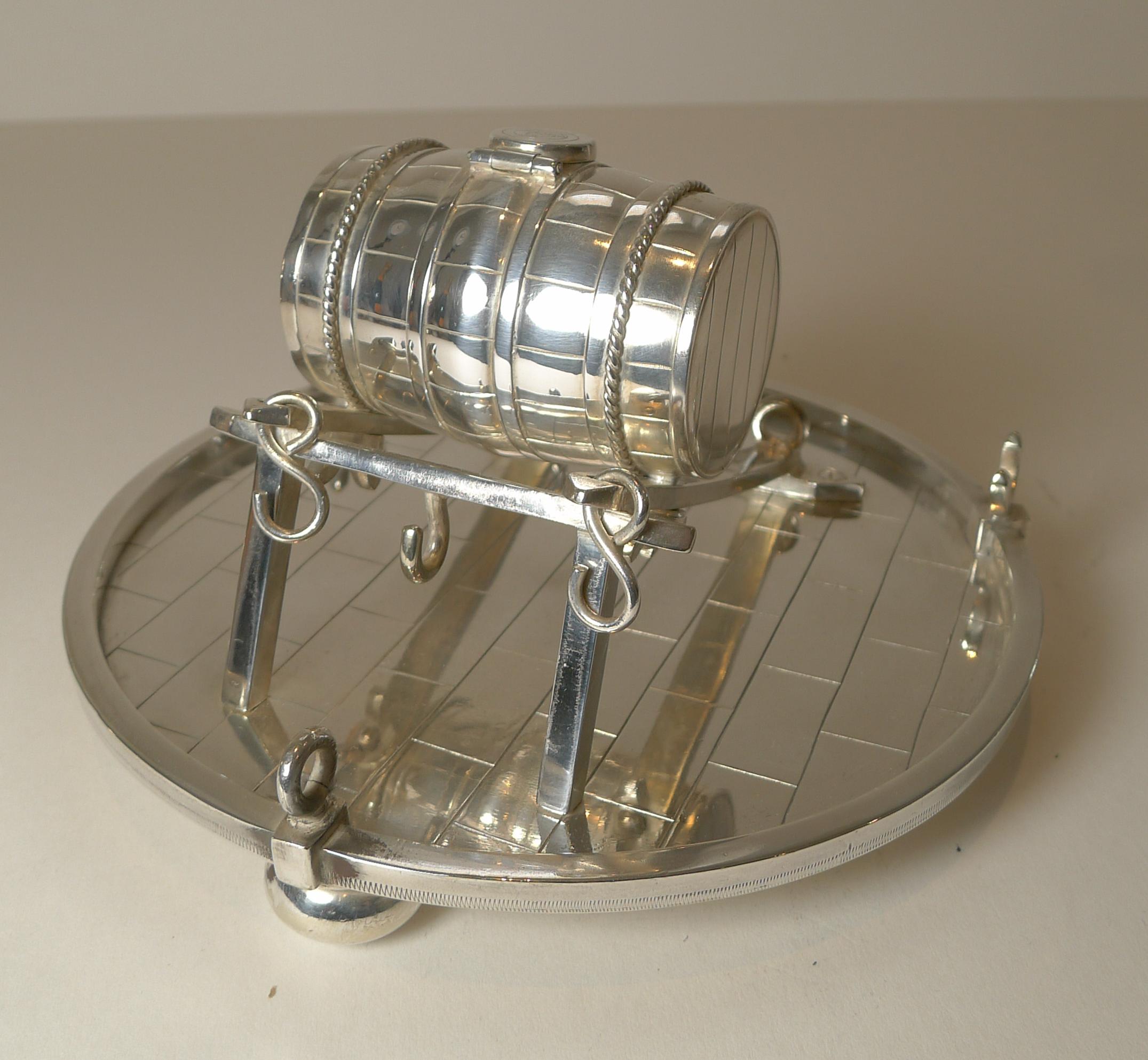 A rare Victorian silver plated novelty inkwell fashioned in the form of a barrel on stand, in turn standing on a brick paving; beautiful detail such as the hooks to the back of the stand and incorporating a pen rest to the front, I am including the