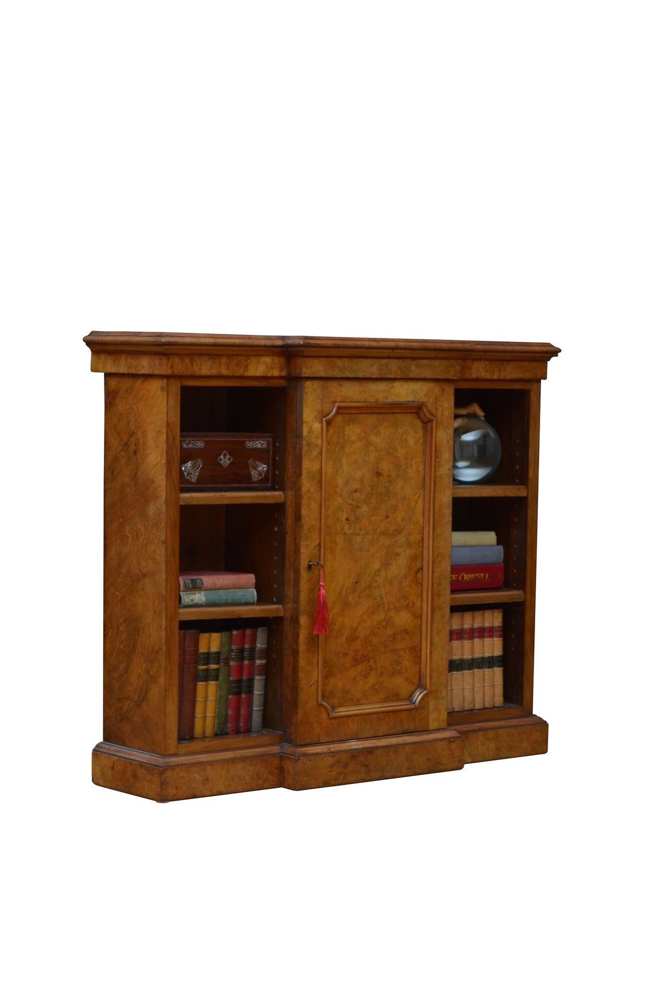 K0617 Superb English Victorian break fronted bookcase / credenza, having burr walnut top with moulded edge above shallow frieze and projecting panelled cupboard door fitted with original working lock, key and hinges and enclosing two height