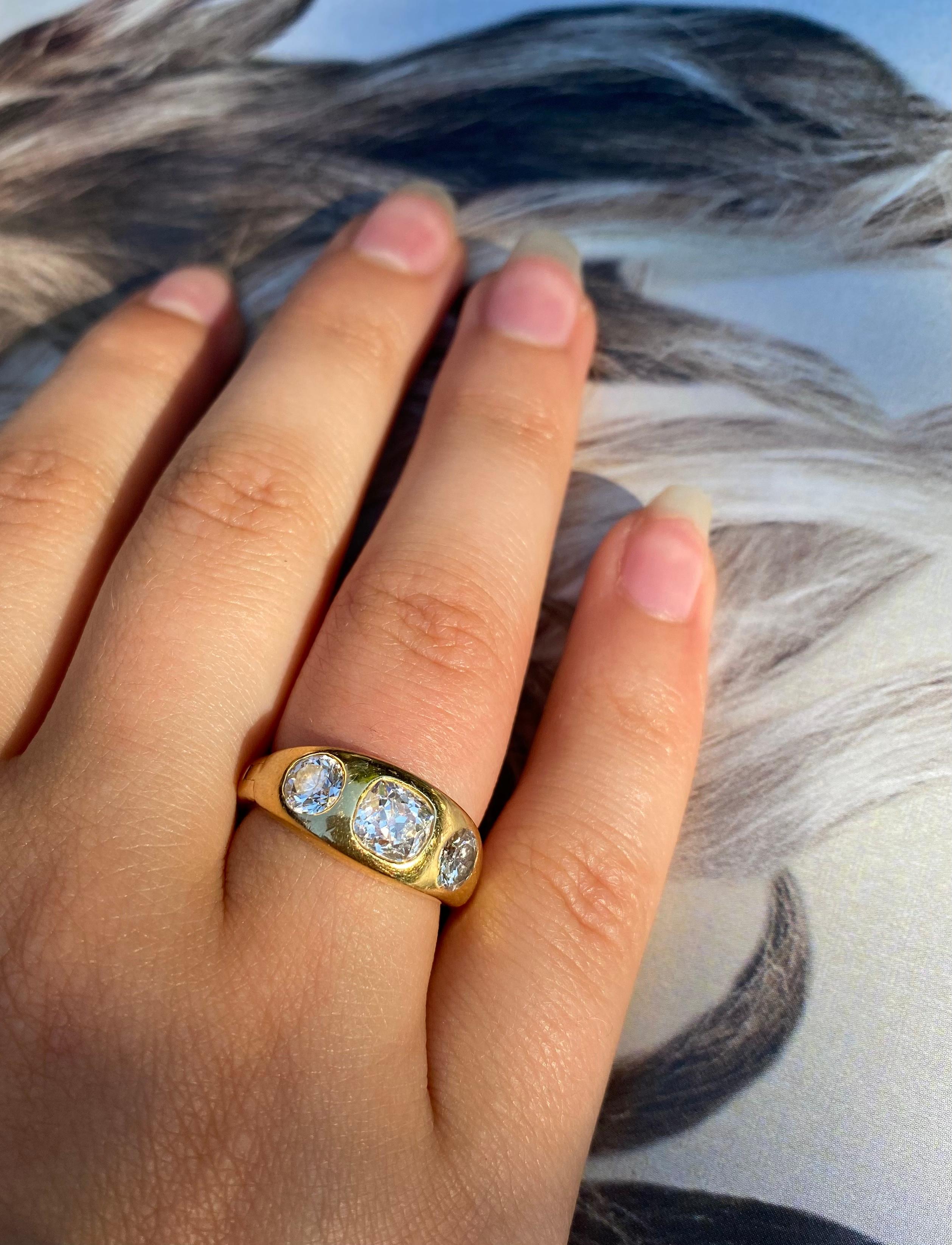 Rare double hinged expandable three stone diamond and 14K yellow gold Gypsy ring.
This ring effortlessly expands from a size 5 US to size 7.75 US with a clever mechanism at the back of the band and the double hinged design at the sides. This allows