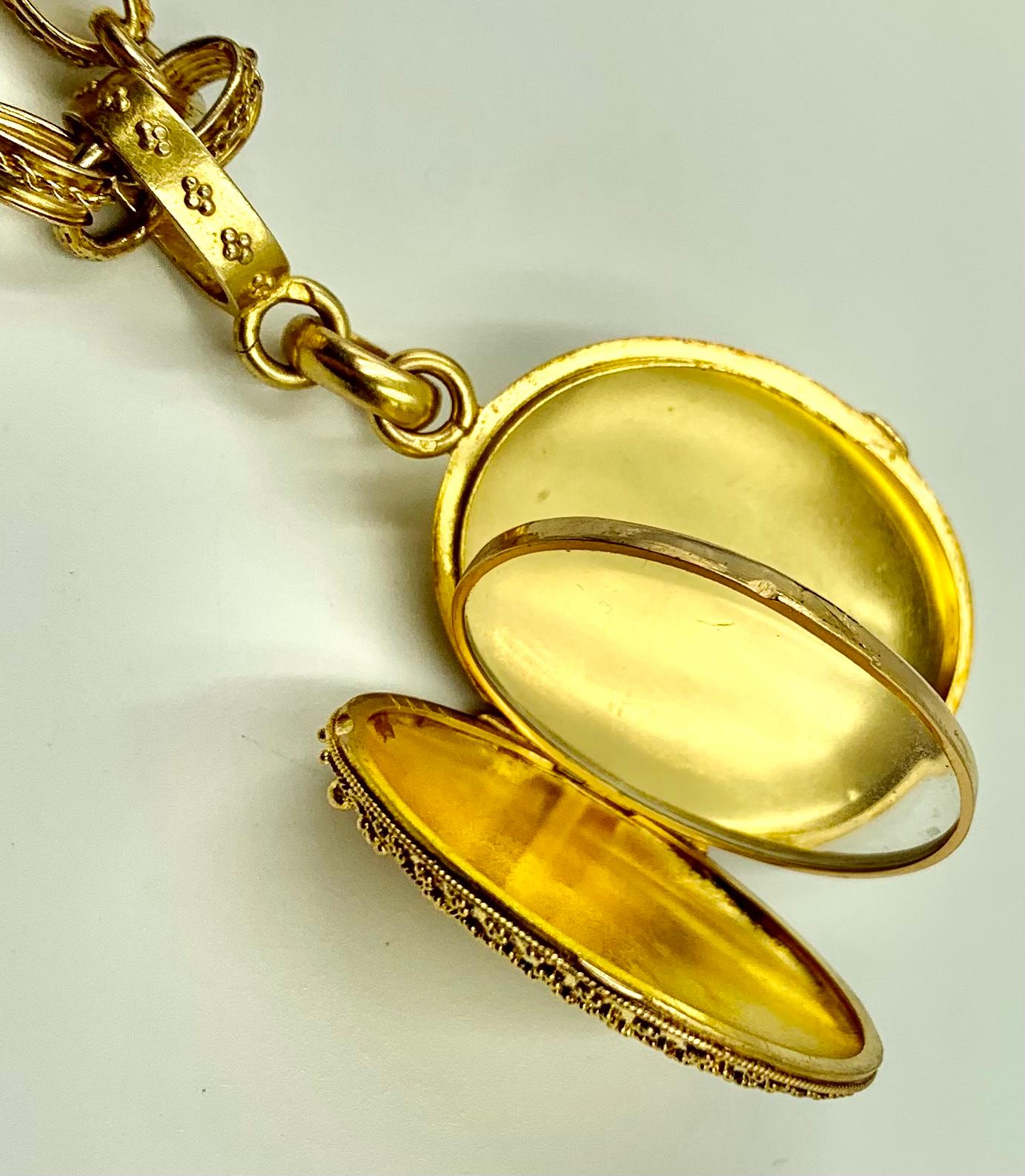 ﻿Large, stunning granulated antique French Etruscan Revival locket with the original, equally spectacular large chain. The oval locket exquisitely decorated with a technique known as granulation, where a tiny gold bead is individually applied to a