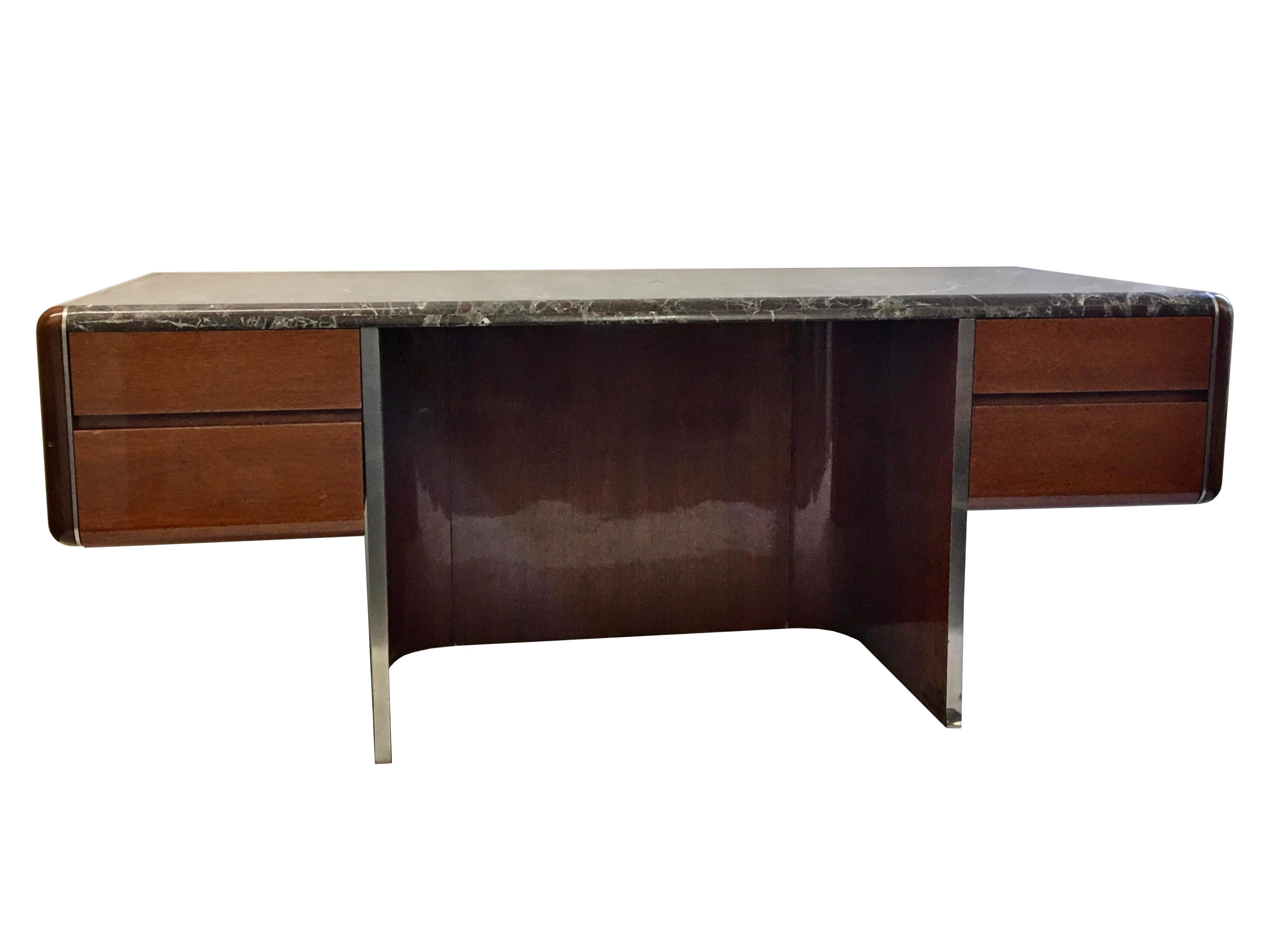 Rare executive desk by Vladimir Kagan comprises a 'floating' upper body made of mahogany wood and marble that is supported on a U-shaped base that has stainless steel on the outer face and polished mahogany veneer on the inner face. The solid wooden