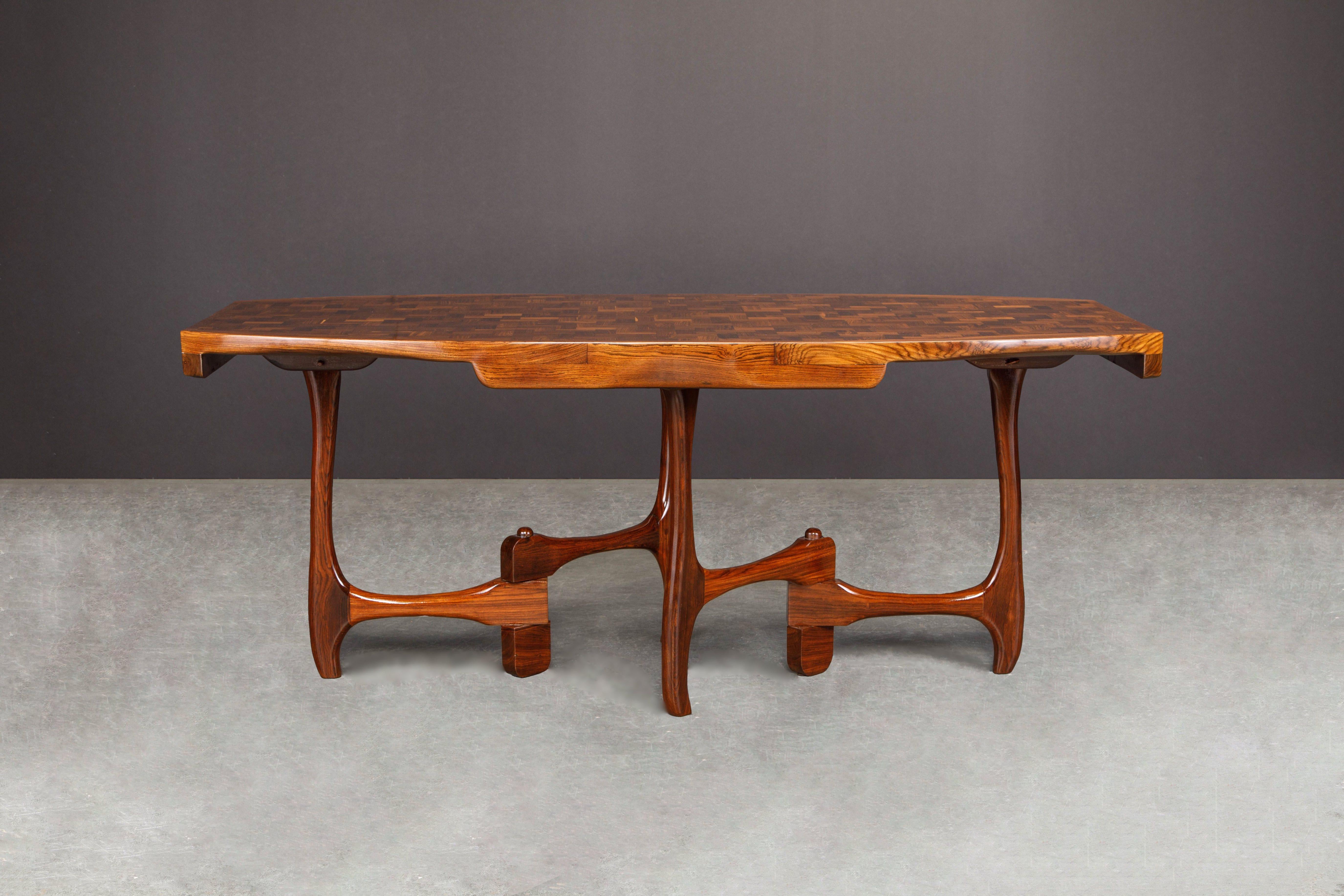 This extremely rare and highly coveted sculptural dining table in exotic Cocobolo Rosewood was designed by leading 1960s modernist designer Don Shoemaker and is signed with a partial Senal S.A. label on the underside. 

We fully restored this