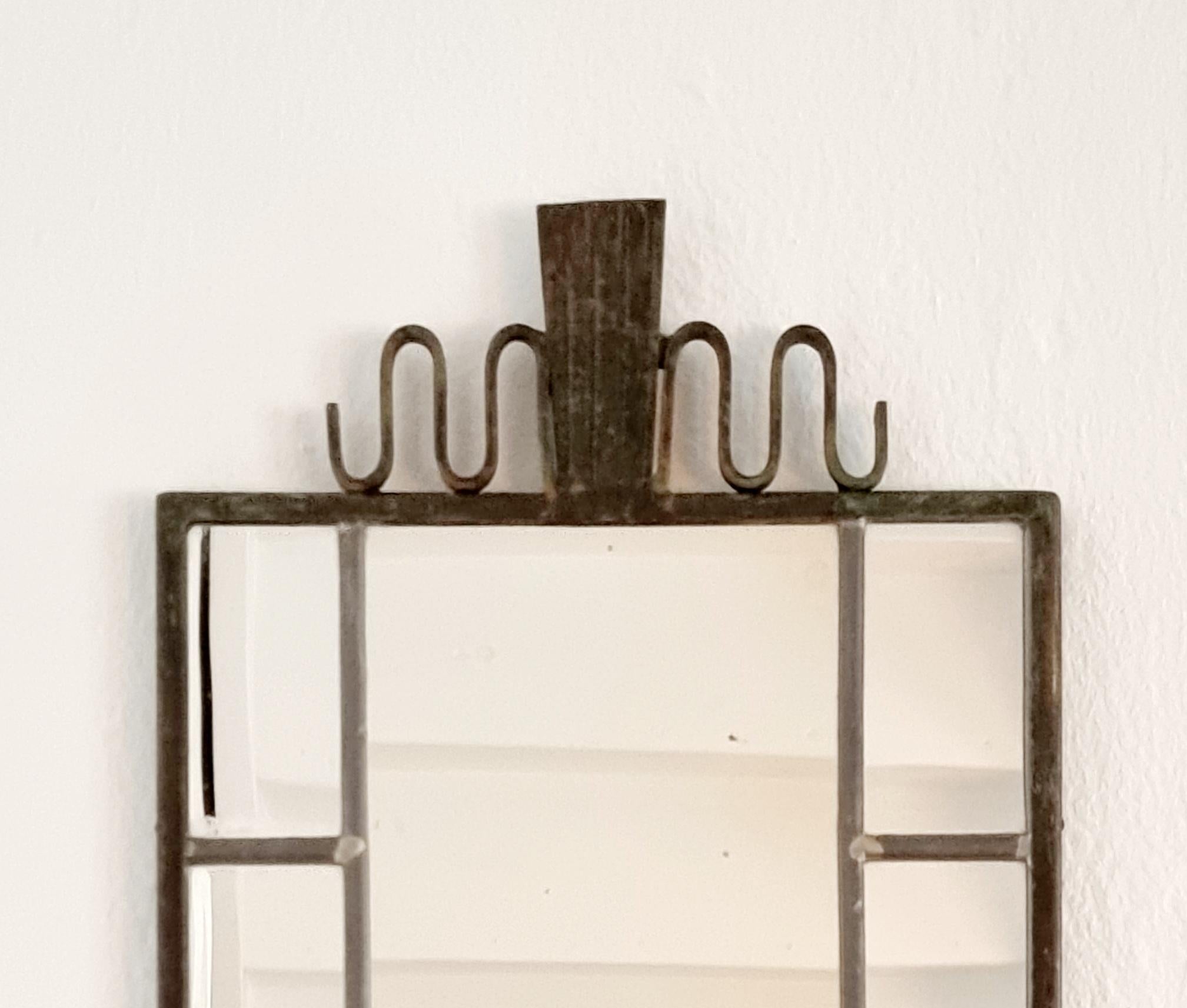 A rare, beautiful Swedish Art Deco mirror in metal with antique bronze finish.

Made by Arvid Böhlmarks lampfabrik ( 1872-1977), one of Swedens most prominent manufacturers of electric and gas lamps.

Smaller signs of wear/age on mirror, small
