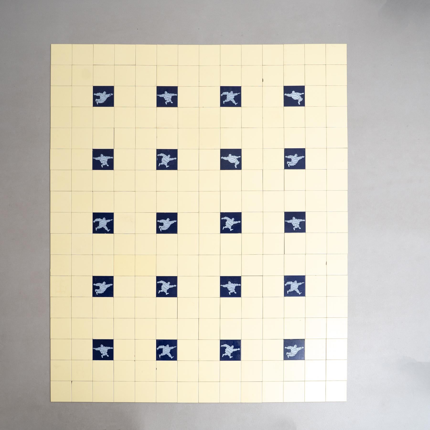 Dive into a nostalgic journey with this rare and unique large set of Michelin Man tiles, crafted by an unknown manufacturer in Spain circa 1960. The set comprises the iconic Michelin Blue Tiles, surrounded by original yellow tiles, creating a