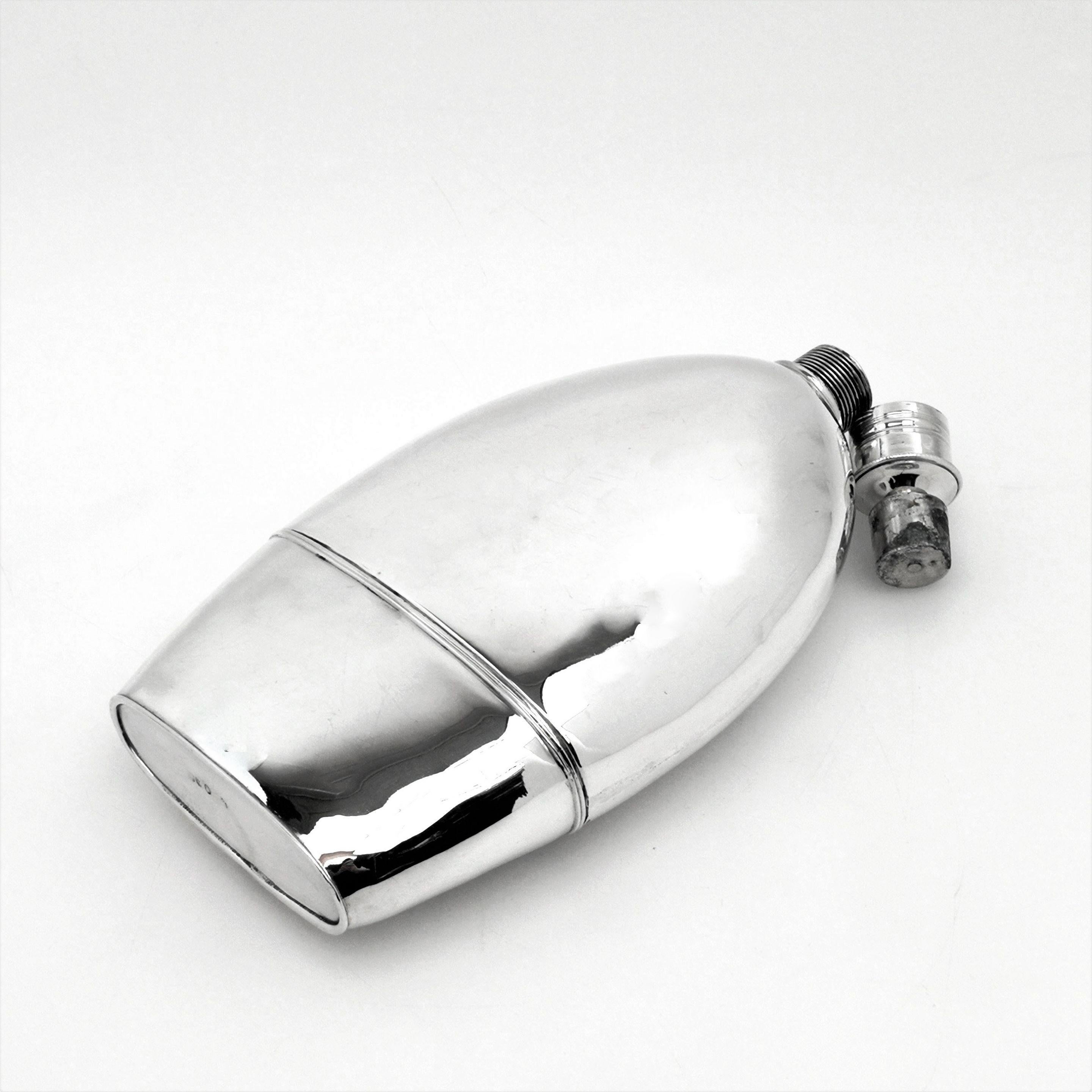 A magnificent George III solid silver flask with a fitted removable cup. The flask has a plain rounded form and has a plain polished silver finish. The screw top cap is inverted to remove the stopper in the Classic Georgian fashion.
 
 Made in