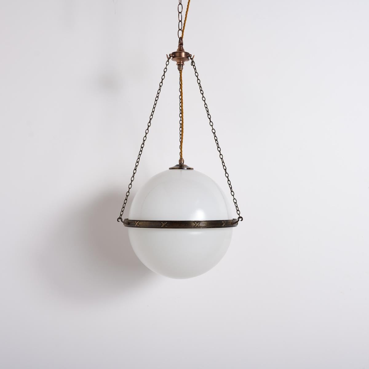 Oversized Opulence: Pair of Extra Large Two-Part Opaline Globes

Enhance your space with this pair of exceptionally large opaline globe pendants. Each 14-inch diameter shade is formed from two opaline hemispheres set within detailed, aged brass