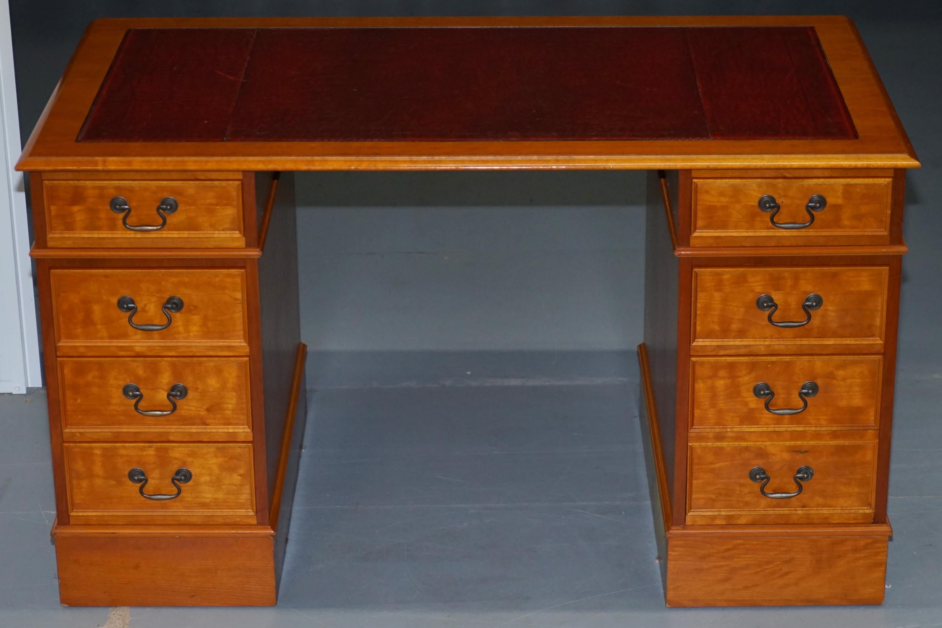 We are delighted to offer for sale this vintage twin pedestal partner desk finished in luxury yew wood with a oxblood leather gold leaf embossed top custom made with extra leg room space

A very good looking and well made desk with a lovely timber
