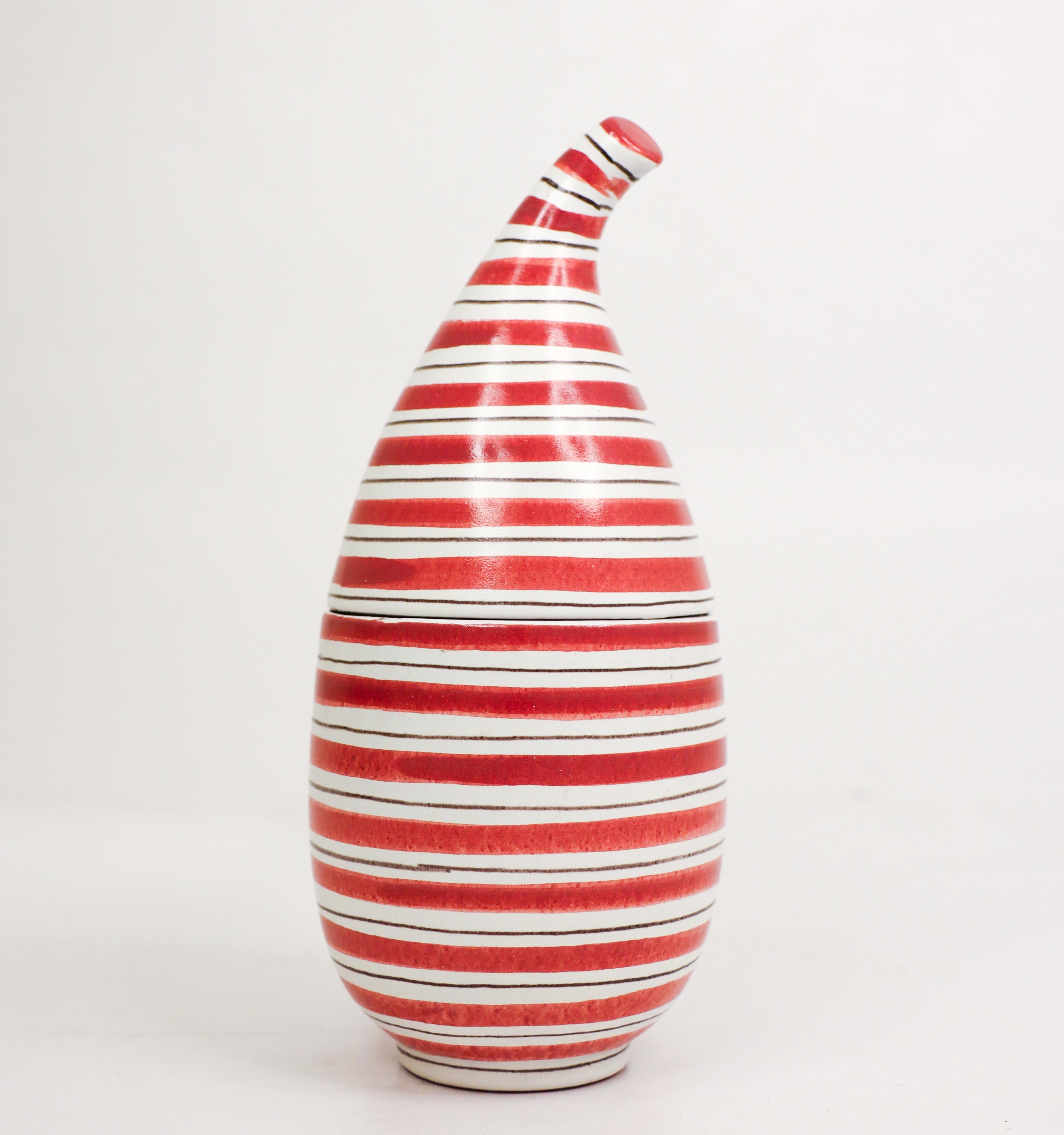 A really rare lidded bowl, red and white striped with lid in faience designed by Stig Lindberg at Gustavsberg in the 1950s. It is 19 cm high and in excellent condition except from two small over-painted chips on the lid and another small mark on the