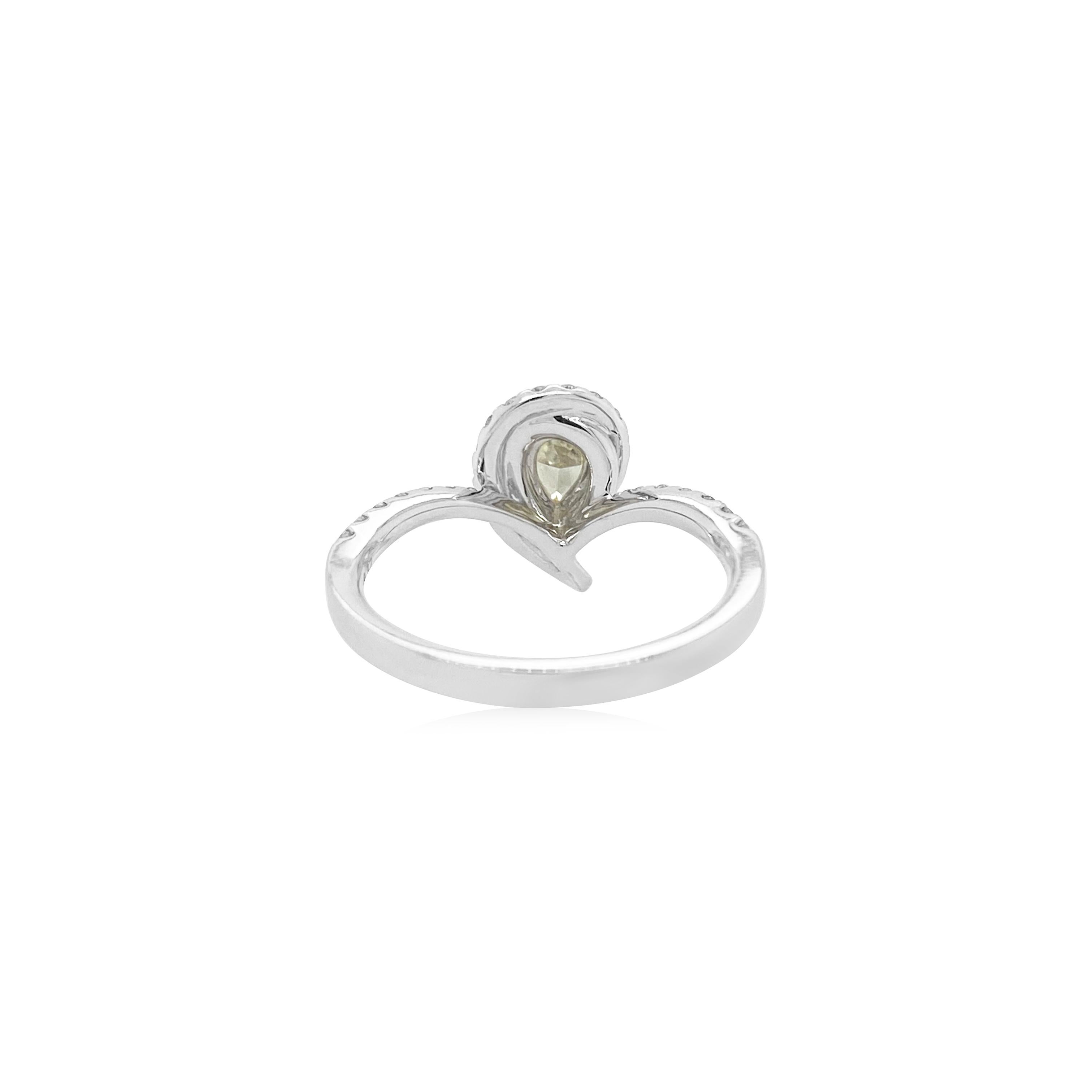 Unique and gorgeous Intense Yellow pear shape Diamond ring. The radiance of diamond is enhanced by scintillating brilliant cut white diamonds.

-	Centre Diamond is CGL Lab Certified Fancy Intense Yellow diamond – 0.313 ct
-	Round Brilliant Cut White