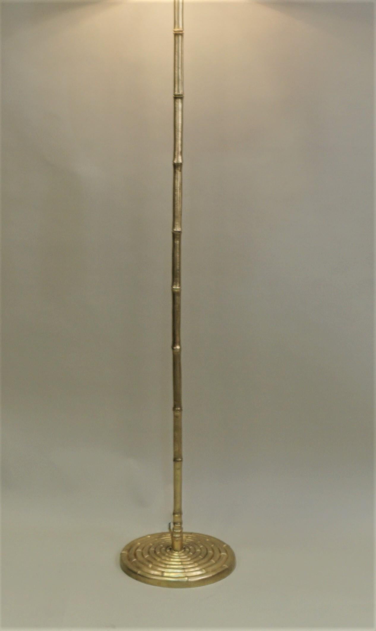 A rare gilt faux bamboo French 1950s floor lamp that has been modified with 3-light and fitted with silk hardback lampshade.