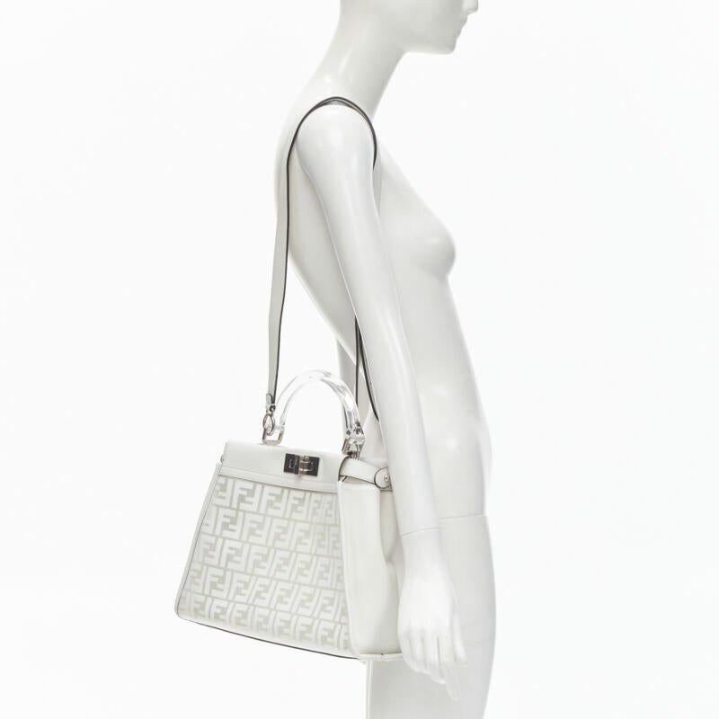 rare FENDI 2019 Limited Peekaboo FF Zucca clear PVC monogram perspex handle bag
Reference: KNLM/A00241
Brand: Fendi
Model: Peekaboo
Collection: 10th Anniversary Collection - Runway
Material: PVC, Leather
Color: White
Pattern: Monogram
Closure:
