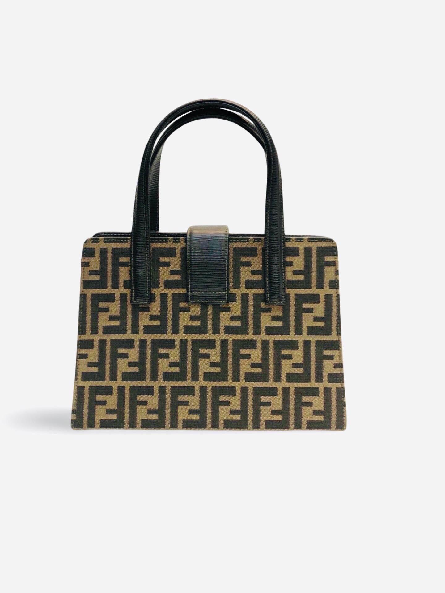 - Fendi zucca print canvas handbag. It is a very structured bag. This style is super rare! 

- Featuring a leather handle, gold toned hardware 