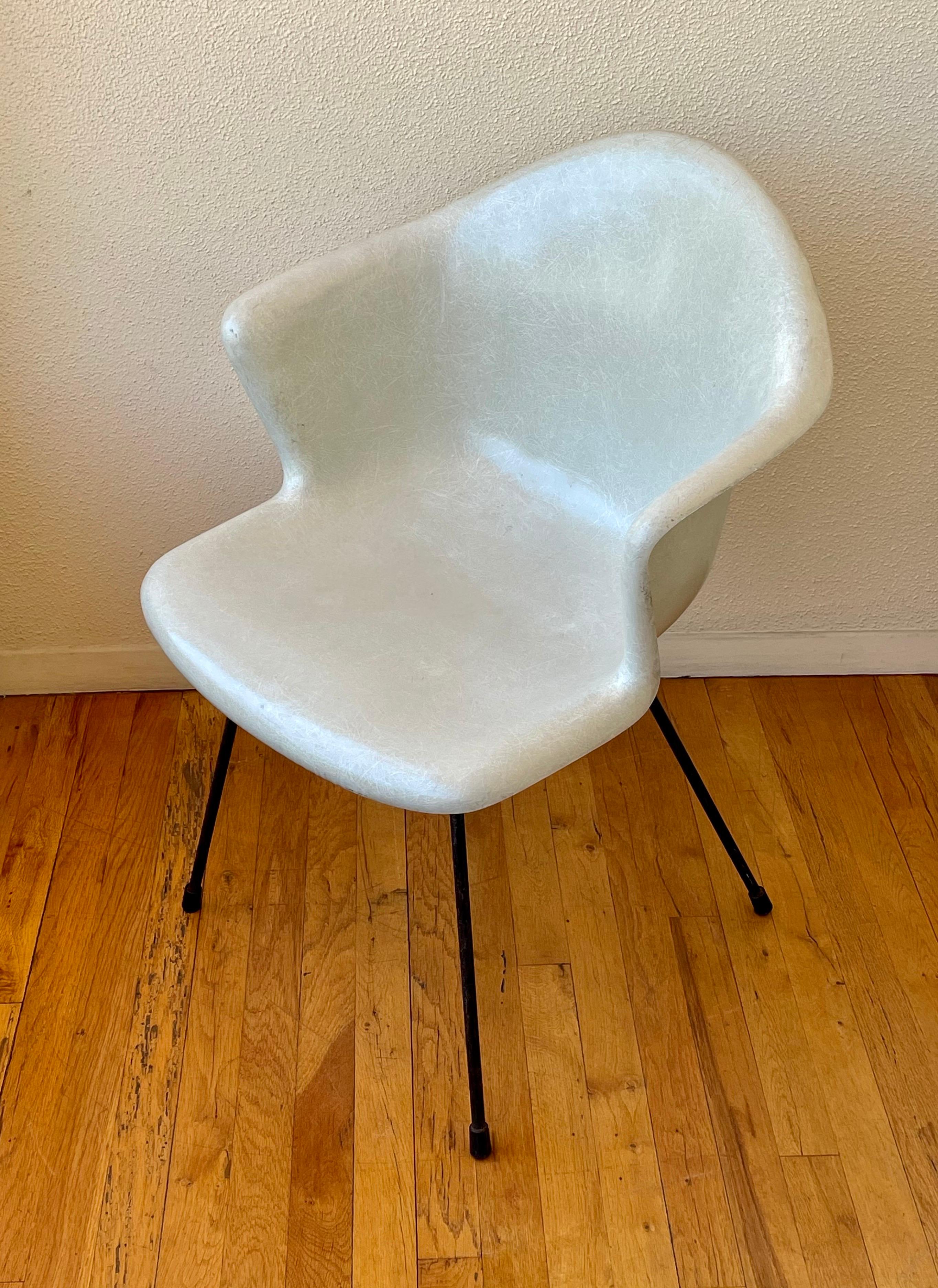 Nice color and condition in this armchair made in molded fiberglass and solid iron base, circa 1950's , classik Atomic age chair in the style of Eames.