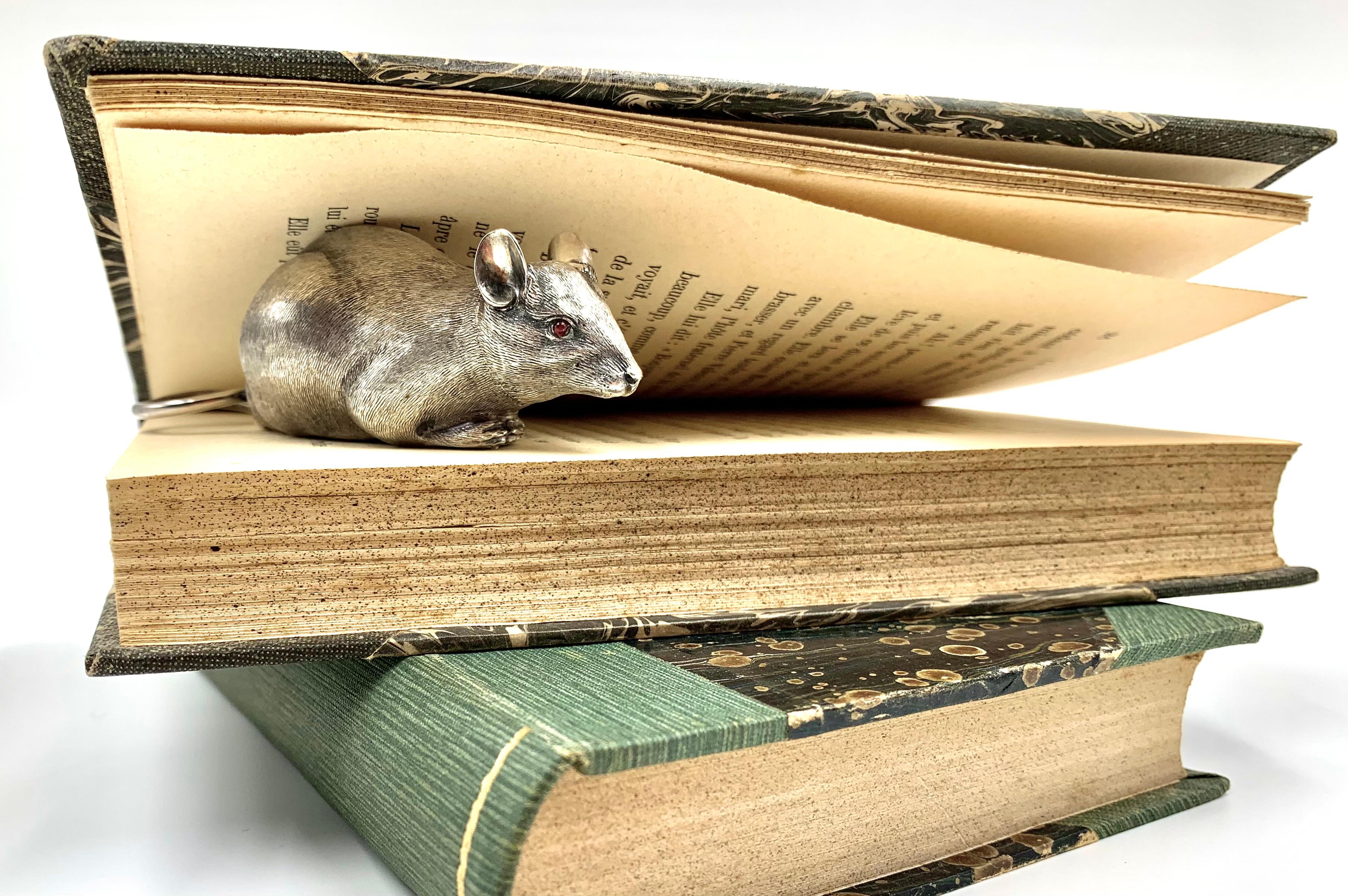 Rare, wonderful antique English sterling silver figural snuff or pill box in the shape of a mouse with cabochon ruby eyes by Thomas Smily, 1884
Superb workmanship with beautifully chased paws, pads, nails and fur. The artistic twirl to the tail