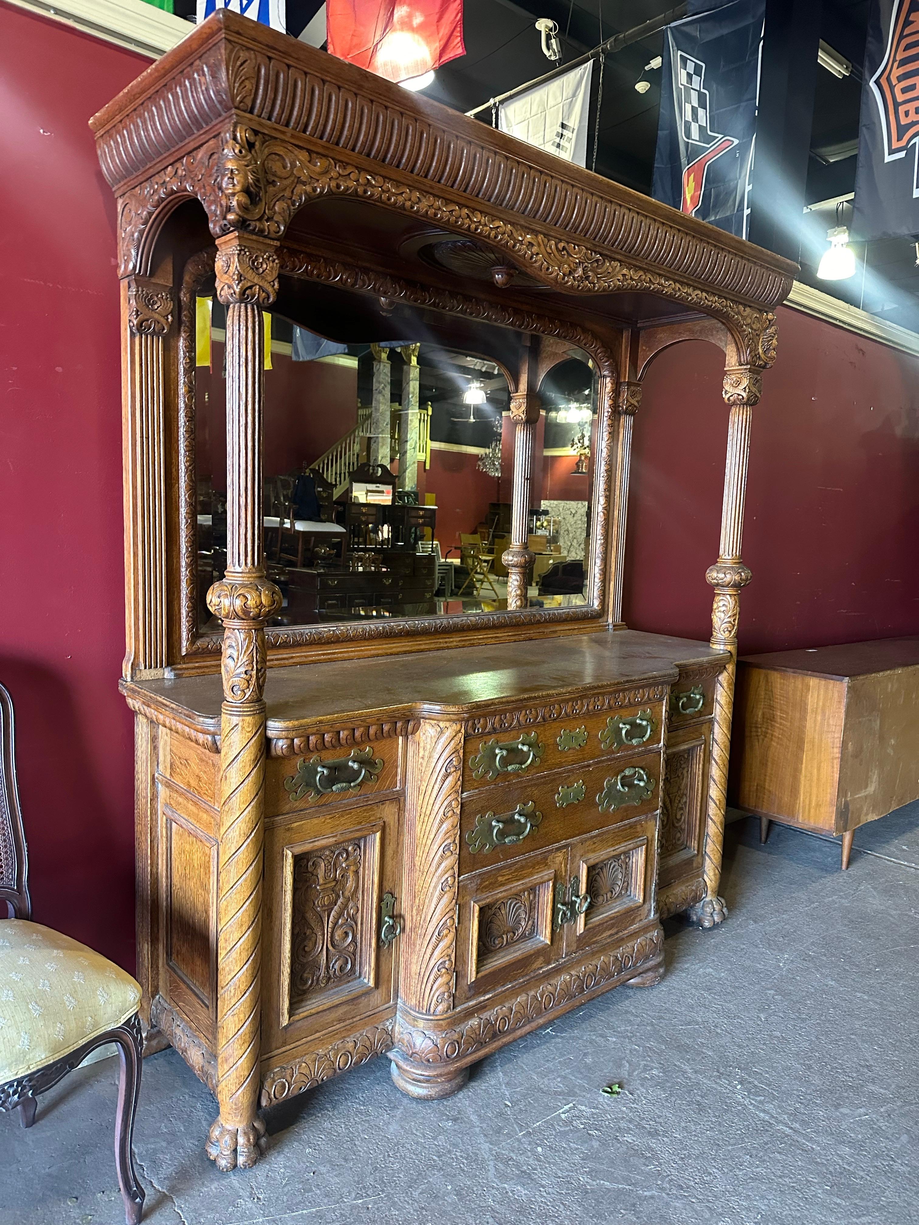 This is a superb quality carved tiger oak or quarter sawn oak huntboard that can easily be used as a backbar or liquor bar. The piece is carved in the manner of R.J. Horner and is most definietly American. The piece dates to the 1880-90s era and has