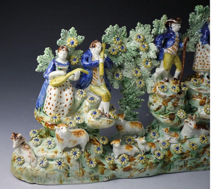 Exceptionally rare figure group by Tittensor, Staffordshire comprising figures and animals in a rural setting with bocage and flowers, circa 1790, Staffordshire England. 

An exceptionally rare and previously unrecorded bocage pearlware figure