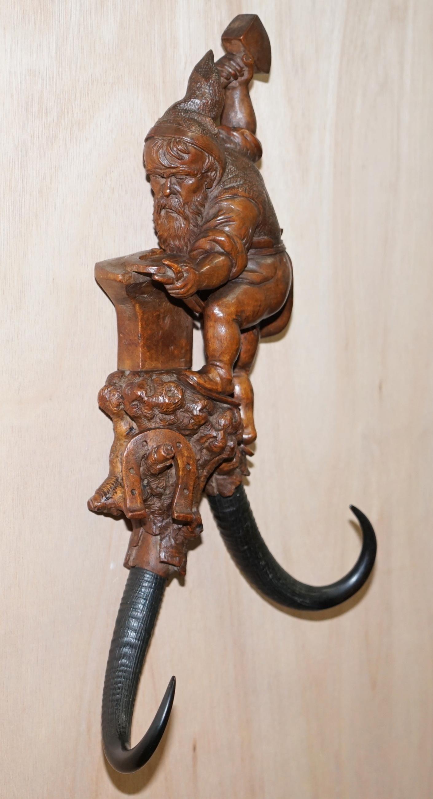 We are delighted to offer for sale this stunning original circa 1890 Swiss black forest wood whip hook of a dwarf blacksmith wielding a hammer

A very rare find, this is a large whip hook, they come in varying sizes and this is the largest I have