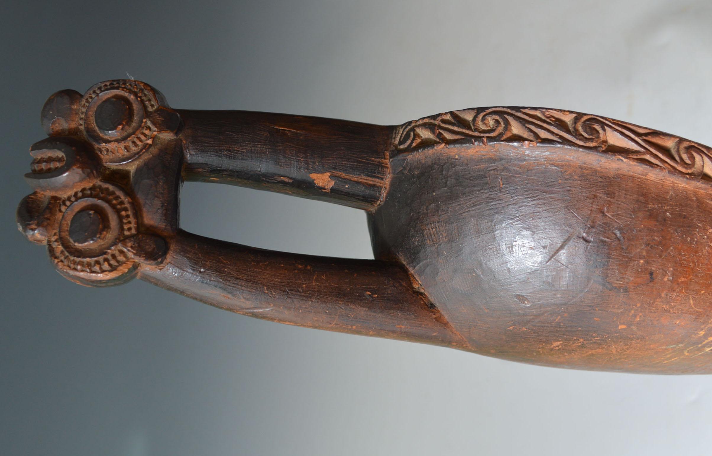 A Very rare and finely carved Maori canoe bailer 
Carved with double Tiki heads from a outward protruding double neck handle
A very rare and finely carved Maori canoe bailer
Carved with double Tiki heads from an outward protruding double neck