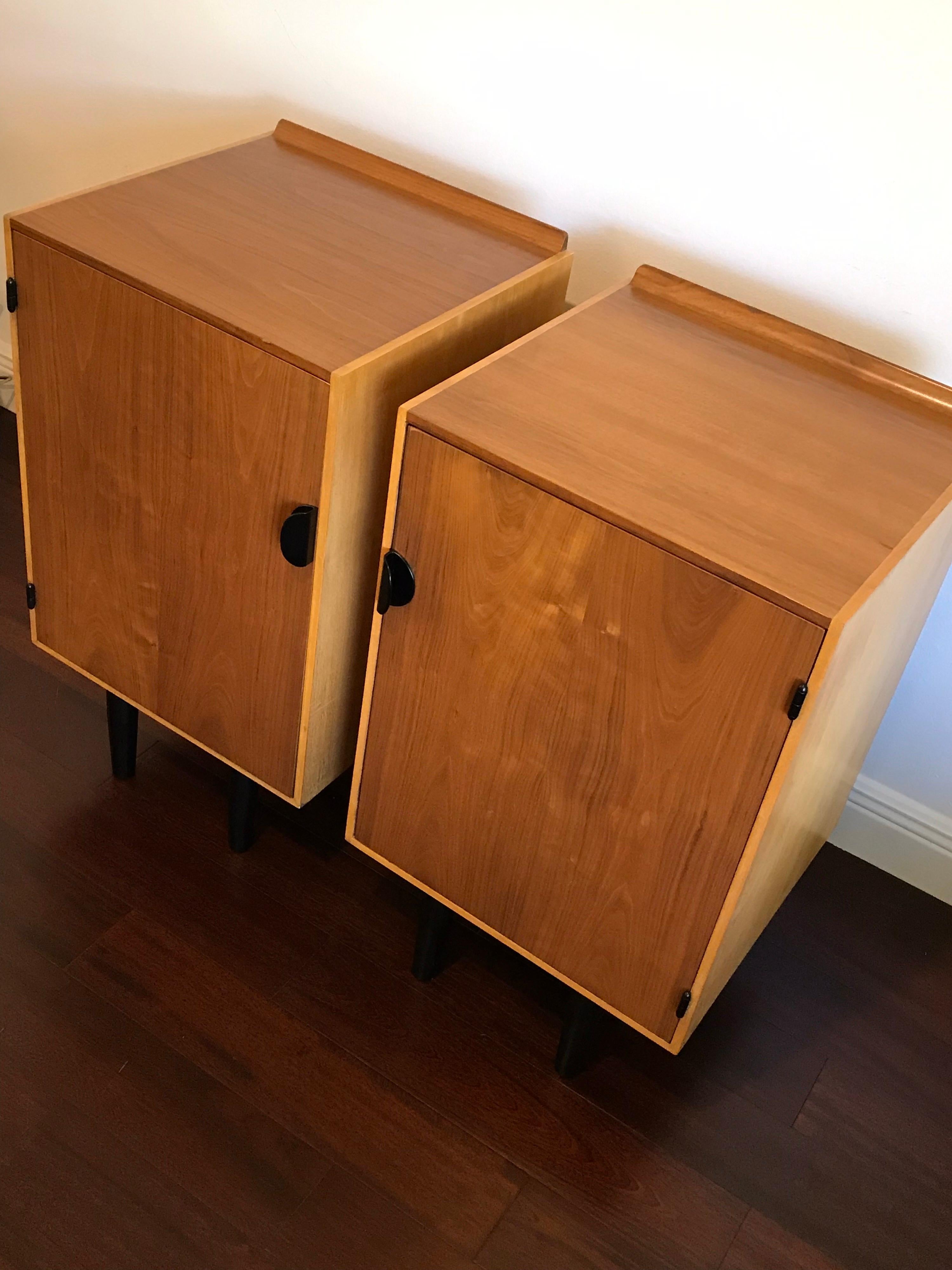 Very rare nightstands or cabinets by Finn Juhl for Baker. These are two-tone with walnut tops and fronts, and birch sides. Each nightstand is accompanied by two drawers and a shelf, which are interchangeable. Very good condition. One cabinet has a