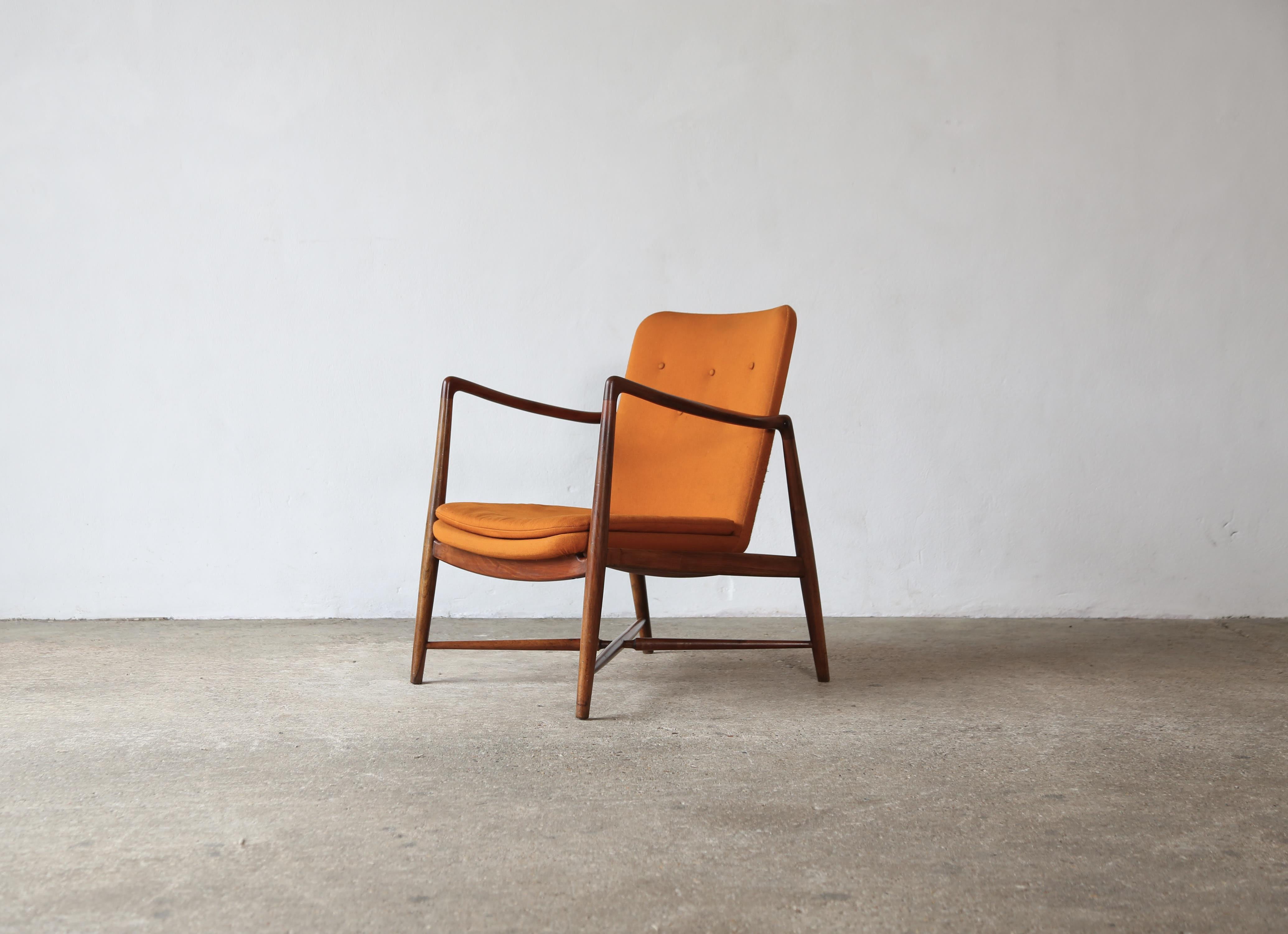 A rare Finn Juhl Fireplace Chair with original fabric.   Model BO59, produced by Bovirke in Denmark, designed 1946, and most likely manufactured in the early 1950s.   Wooden frames in very good original condition.  Original orange fabric with minor