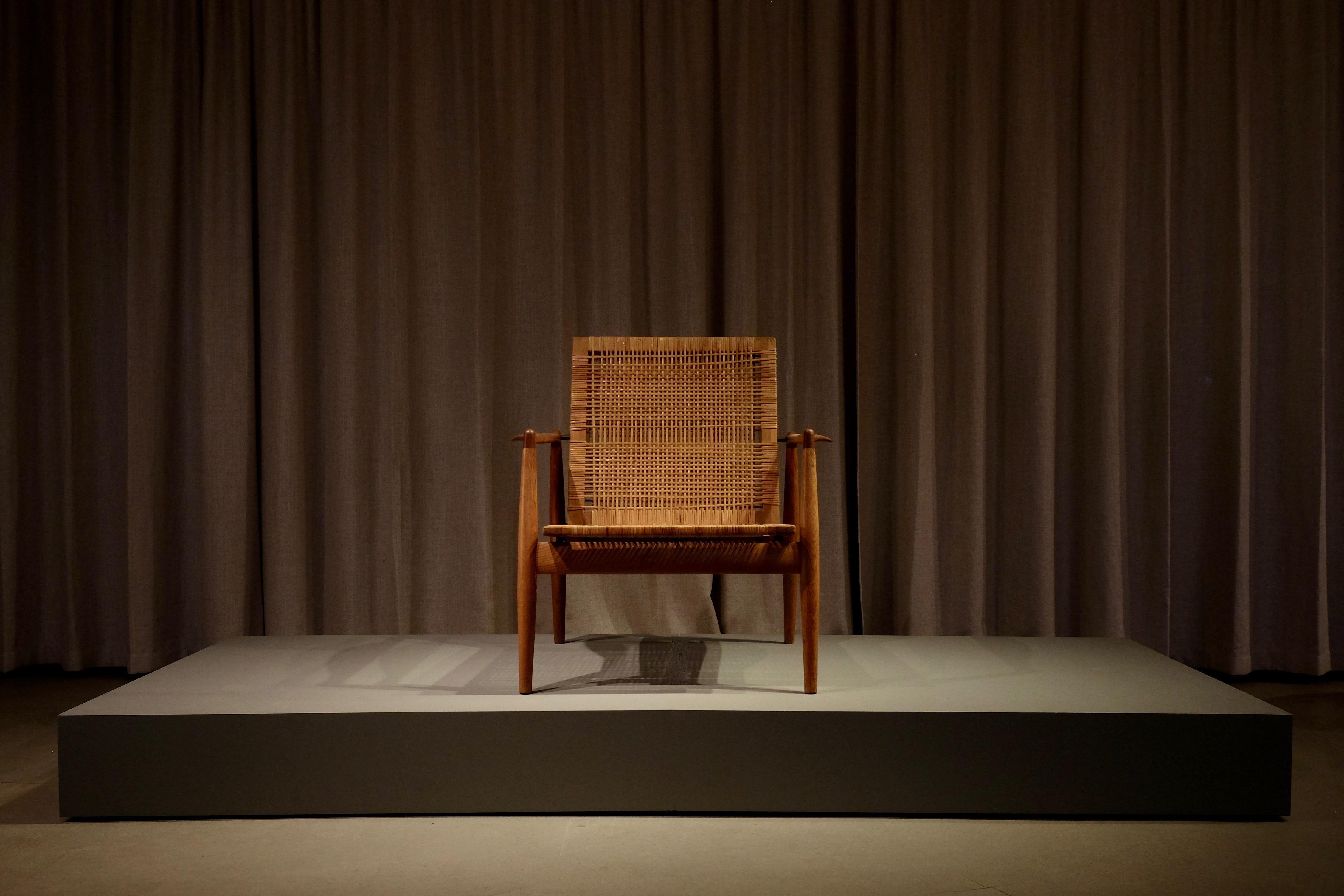 Magnifique fauteuil Finn Juhl avec structure en chêne patiné d'origine, accoudoirs en teck, dossier et assise tapissés de rotin tressé.

Conçu par Finn Juhl 1954, fabriqué par Søren Willadsen, Danemark années 1950, modèle SW96. Exécuté en nombre